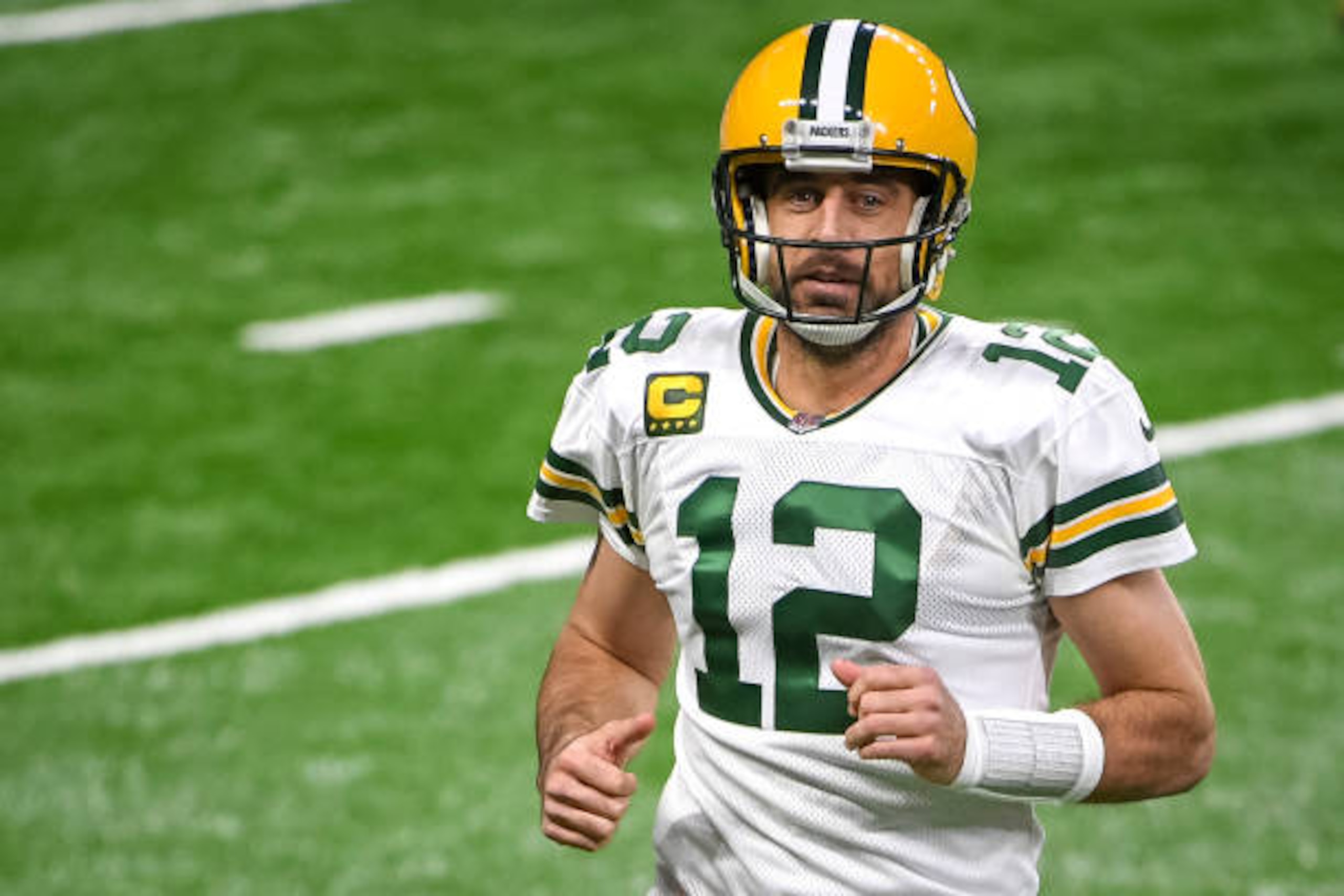 DETROIT, MICHIGAN - DECEMBER 13: Aaron Rodgers #12 of the Green Bay Packers runs off the field during the first half against the Detroit Lions at Ford Field on December 13, 2020 in Detroit, Michigan. (Photo by Nic Antaya/Getty Images)