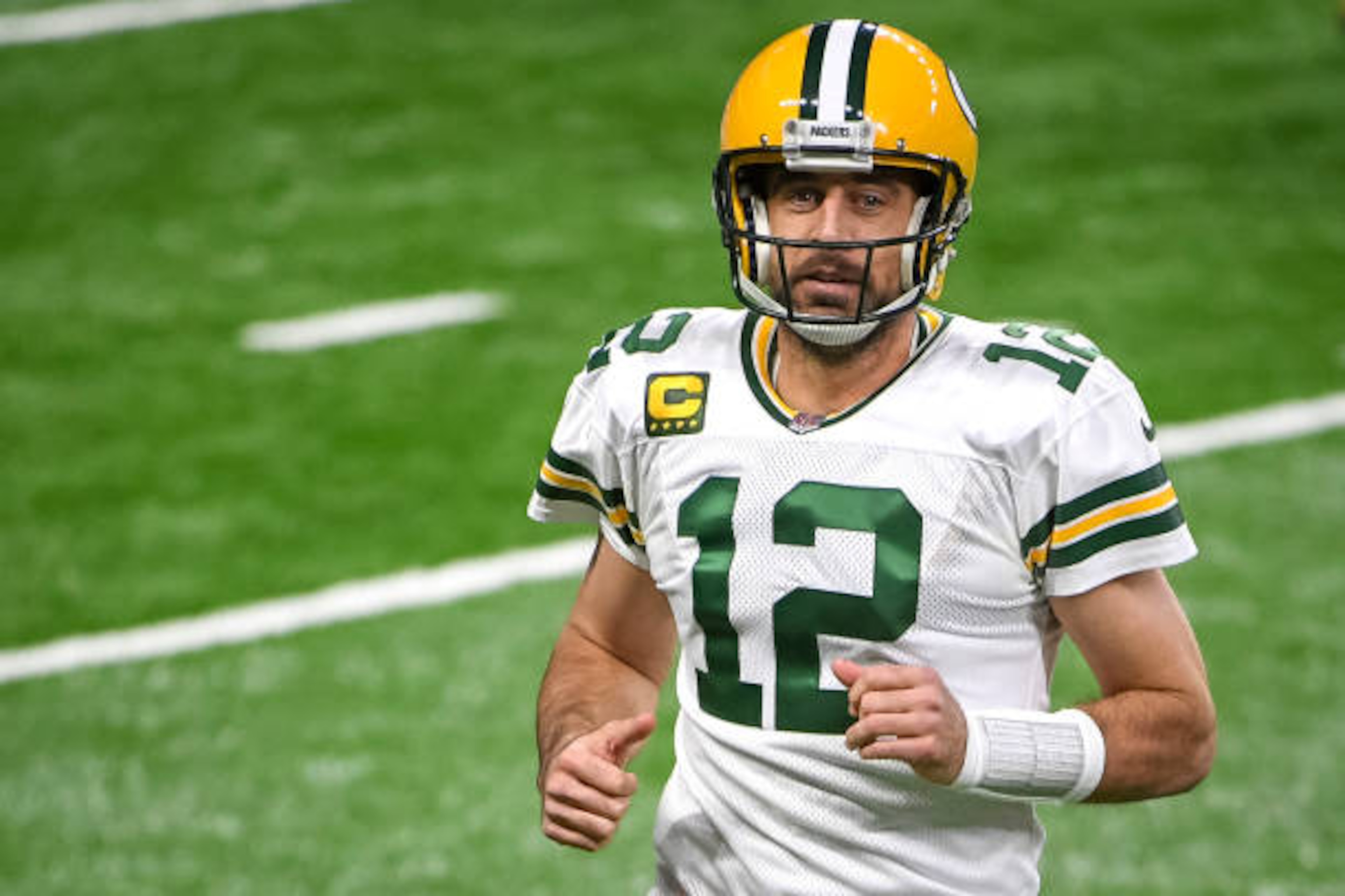 DETROIT, MICHIGAN - DECEMBER 13: Aaron Rodgers #12 of the Green Bay Packers runs off the field during the first half against the Detroit Lions at Ford Field on December 13, 2020 in Detroit, Michigan. (Photo by Nic Antaya/Getty Images) DETROIT, MICHIGAN - DECEMBER 13: Aaron Rodgers #12 of the Green Bay Packers runs off the field during the first half against the Detroit Lions at Ford Field on December 13, 2020 in Detroit, Michigan. (Photo by Nic Antaya/Getty Images)