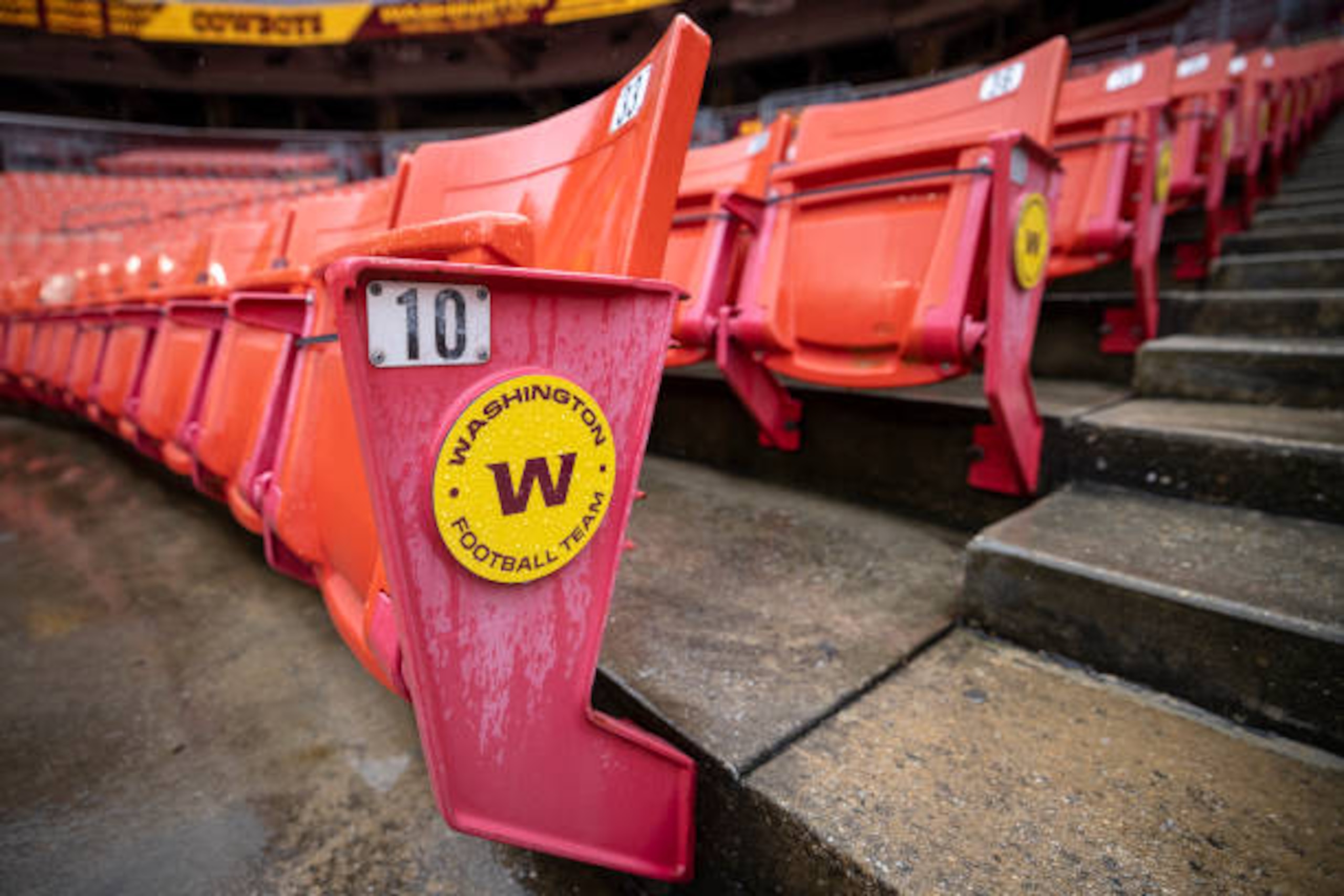LANDOVER, MD - OCTOBER 25: A general view of an empty section of seats with a Washington Football Team logo before the game between the Washington Football Team and the Dallas Cowboys at FedExField on October 25, 2020 in Landover, Maryland. A limited number of friends and family were allowed to attend the game due to the novel coronavirus (COVID-19) pandemic. (Photo by Scott Taetsch/Getty Images)