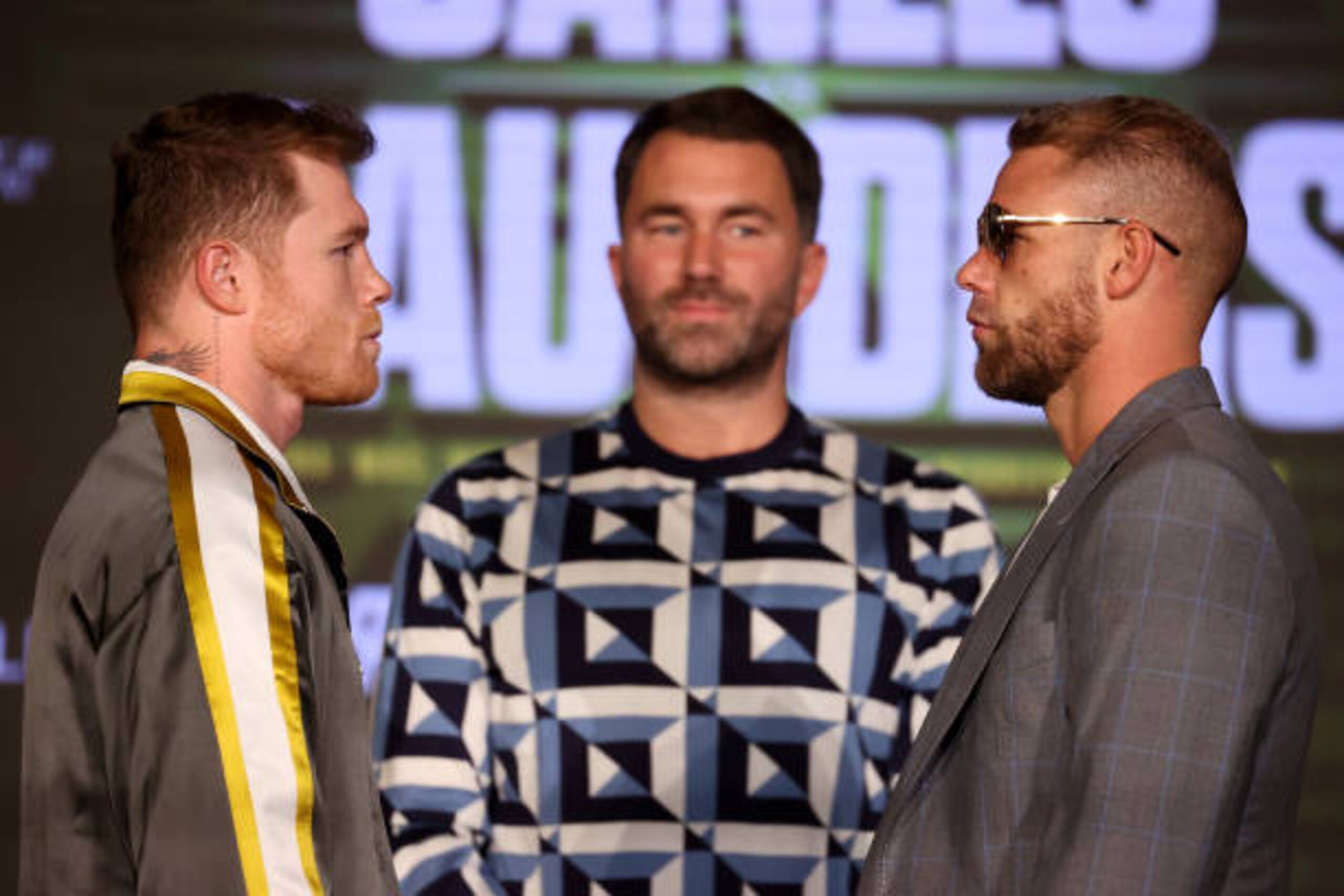 ARLINGTON, TEXAS - MAY 06: Canelo Alvarez and Billy Joe Saunders face off with Matchroom Promoter Eddie Hearn looking on during the press conference for Alvarez's WBC and WBA super middleweight titles and Saunders' WBO super middleweight title at Live! by Loews hotel on May 06, 2021 in Arlington, Texas. (Photo by Al Bello/Getty Images) ARLINGTON, TEXAS - MAY 06: Canelo Alvarez and Billy Joe Saunders face off with Matchroom Promoter Eddie Hearn looking on during the press conference for Alvarez's WBC and WBA super middleweight titles and Saunders' WBO super middleweight title at Live! by Loews hotel on May 06, 2021 in Arlington, Texas. (Photo by Al Bello/Getty Images)