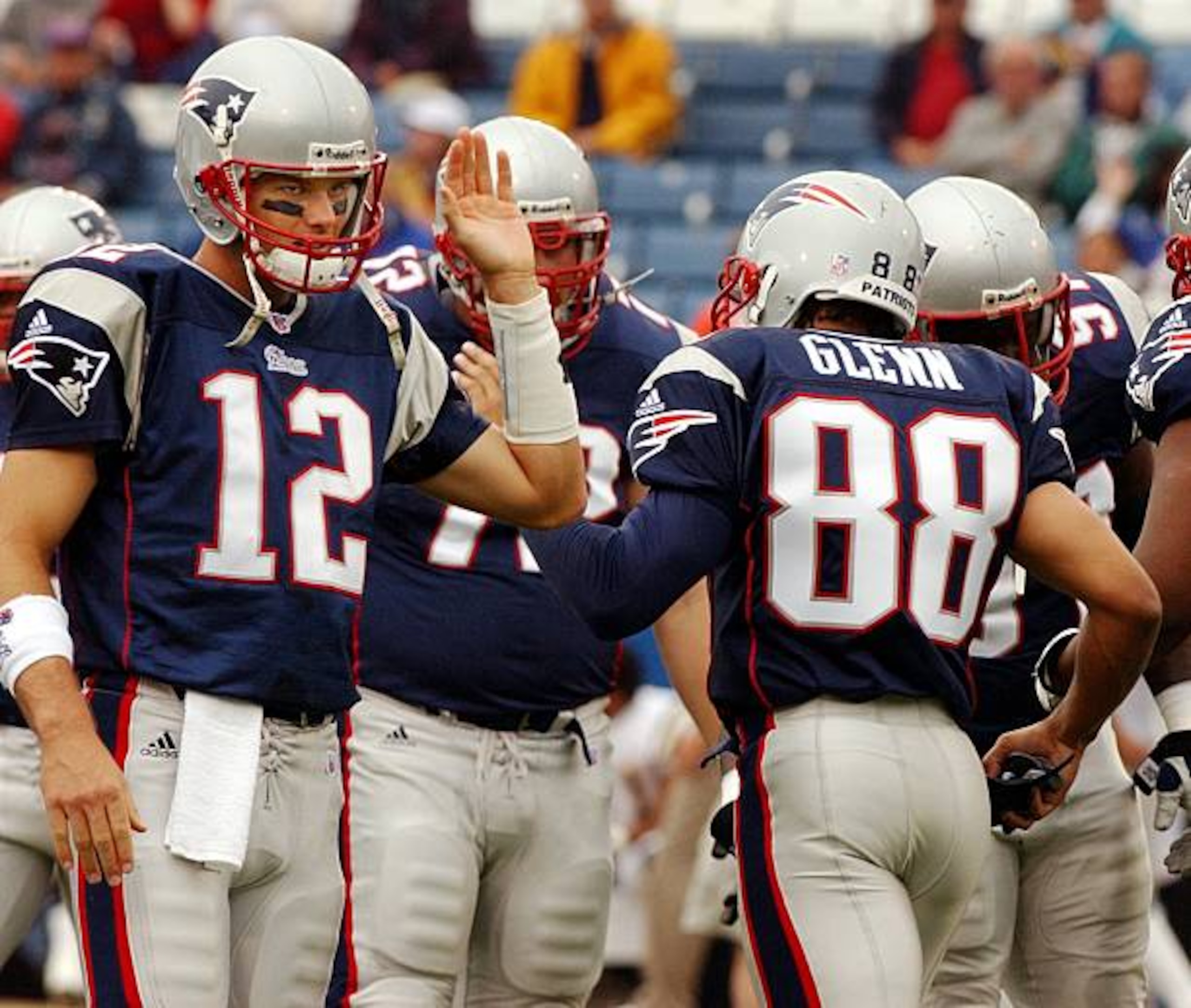FOXBOROUGH, MA - OCTOBER 14: Patriots quarterback Tom Brady (left),was happy to see suspended wide receiver Terry Glenn (#88) as he comes onto the field, and gives him a high five prior to New England's 29-26 come from behind victory over the San Diego Chargers. He was probably more happy that he was back later in the afternoon, as the two teamed to help lead the home team to a win. (Photo by Jim Davis/The Boston Globe via Getty Images) FOXBOROUGH, MA - OCTOBER 14: Patriots quarterback Tom Brady (left),was happy to see suspended wide receiver Terry Glenn (#88) as he comes onto the field, and gives him a high five prior to New England's 29-26 come from behind victory over the San Diego Chargers. He was probably more happy that he was back later in the afternoon, as the two teamed to help lead the home team to a win. (Photo by Jim Davis/The Boston Globe via Getty Images)