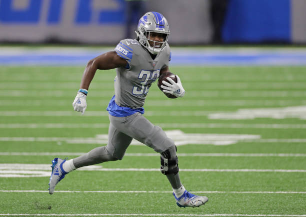 DETROIT, MICHIGAN - DECEMBER 26: Kerryon Johnson #33 of the Detroit Lions runs for a first down during the first quarter of the game against Tampa Bay at Ford Field on December 26, 2020 in Detroit, Michigan. Tampa defeated Detroit 47-7 (Photo by Leon Halip/Getty Images)