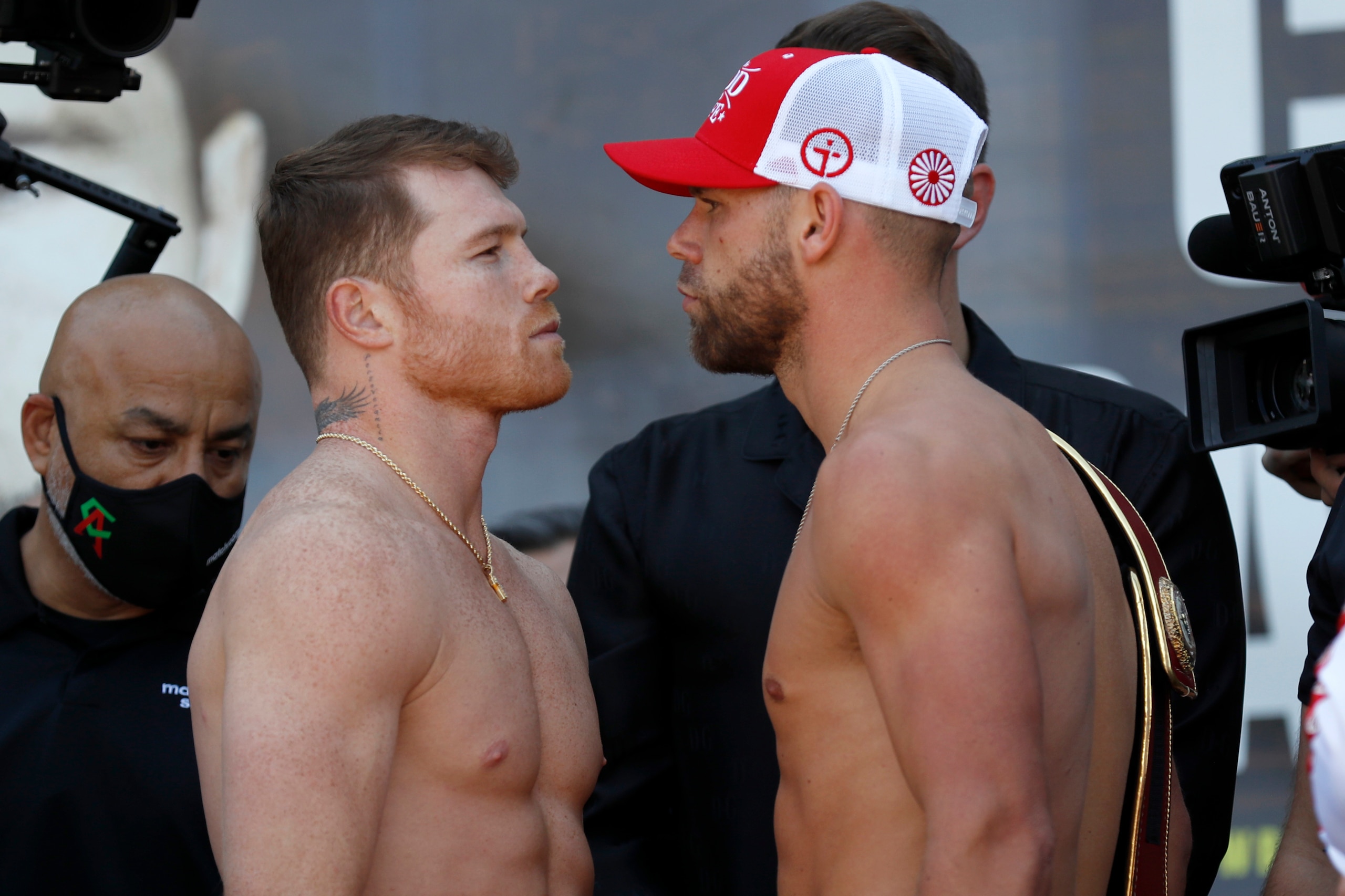 Canelo Alvarez, front left, and Billy Joe Saunders, right pose for a face off after their weigh-ins on Friday, May 7, 2021, in Arlington, Texas. Alvarez and Saunders fight on Saturday, May 8, 2021, for the unified super middleweight world championship. (AP Photo/Roger Steinman)