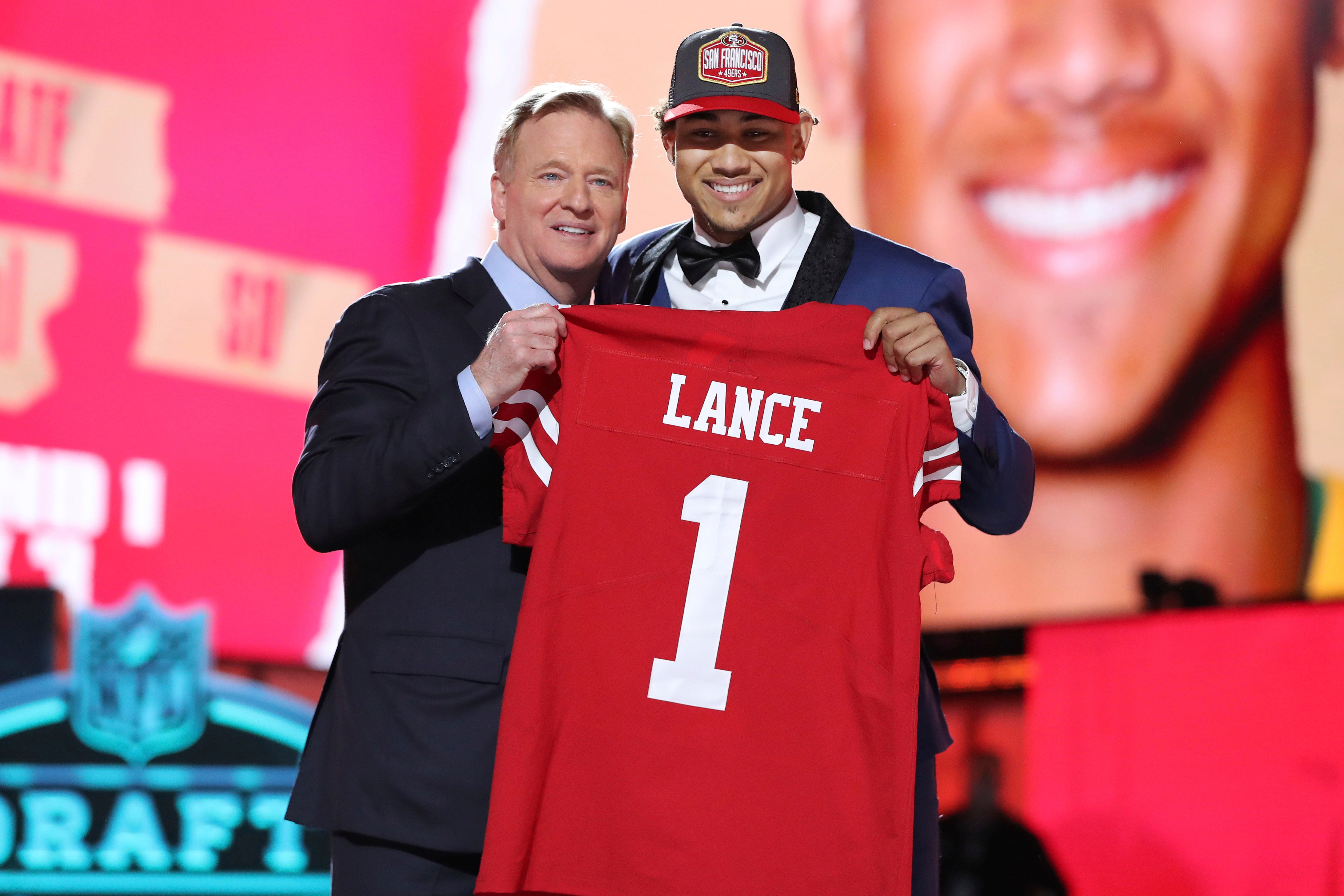 North Dakota State quarterback Trey Lance, right, holds a team jersey with NFL Commissioner Roger Goodell after the San Francisco 49ers selected Lance with the 3rd pick in the first round of the NFL football draft Thursday April 29, 2021, in Cleveland. (AP Photo/Gregory Payan)