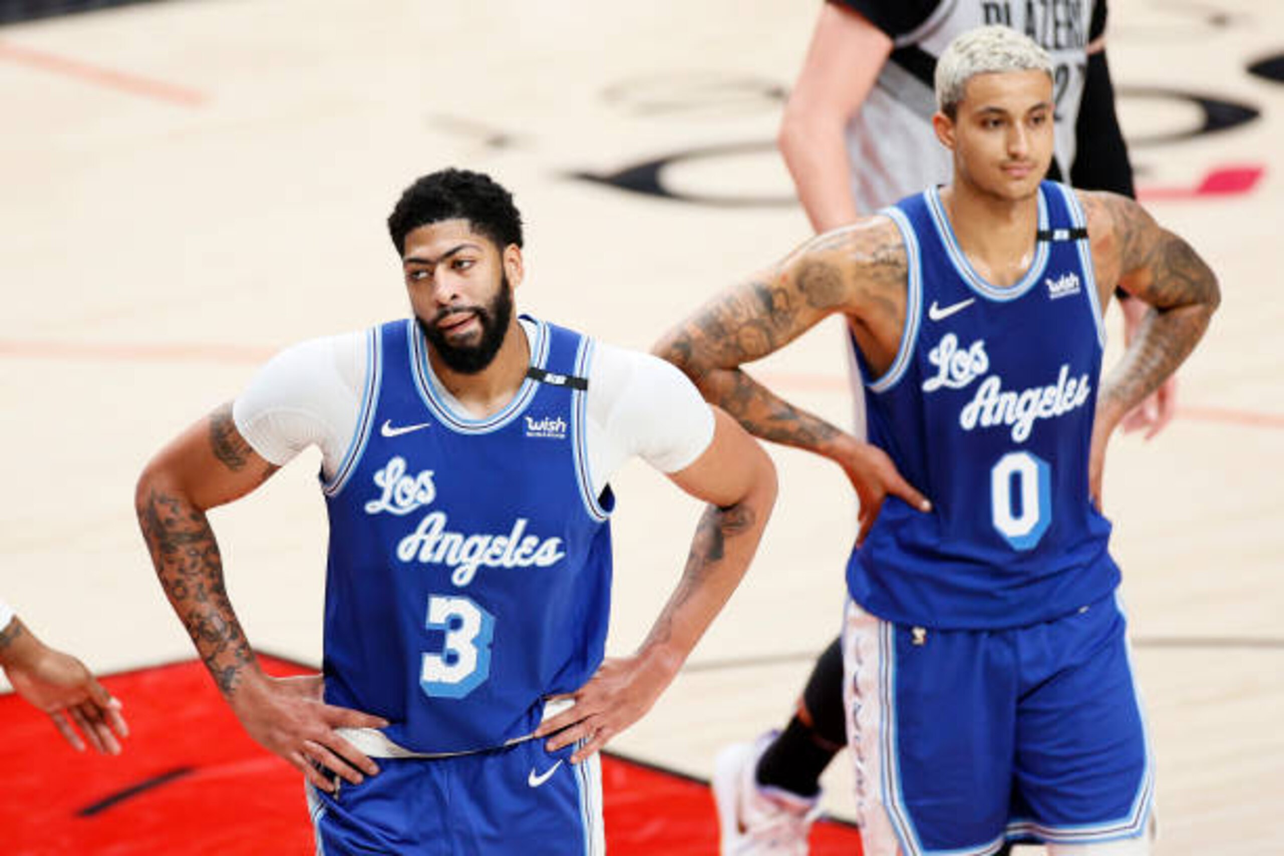 PORTLAND, OREGON - MAY 07: Anthony Davis #3 and Kyle Kuzma #0 of the Los Angeles Lakers react during the third quarter against the Portland Trail Blazers at Moda Center on May 07, 2021 in Portland, Oregon. NOTE TO USER: User expressly acknowledges and agrees that, by downloading and or using this photograph, User is consenting to the terms and conditions of the Getty Images License Agreement. (Photo by Steph Chambers/Getty Images)