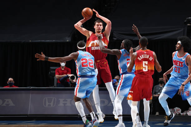BROOKLYN, NY - JANUARY 12: Nikola Jokic #15 of the Denver Nuggets looks to pass the ball during the game against the Brooklyn Nets on January 12, 2021 at Barclays Center in Brooklyn, New York. NOTE TO USER: User expressly acknowledges and agrees that, by downloading and or using this Photograph, user is consenting to the terms and conditions of the Getty Images License Agreement. Mandatory Copyright Notice: Copyright 2021 NBAE (Photo by Nathaniel S. Butler/NBAE via Getty Images)