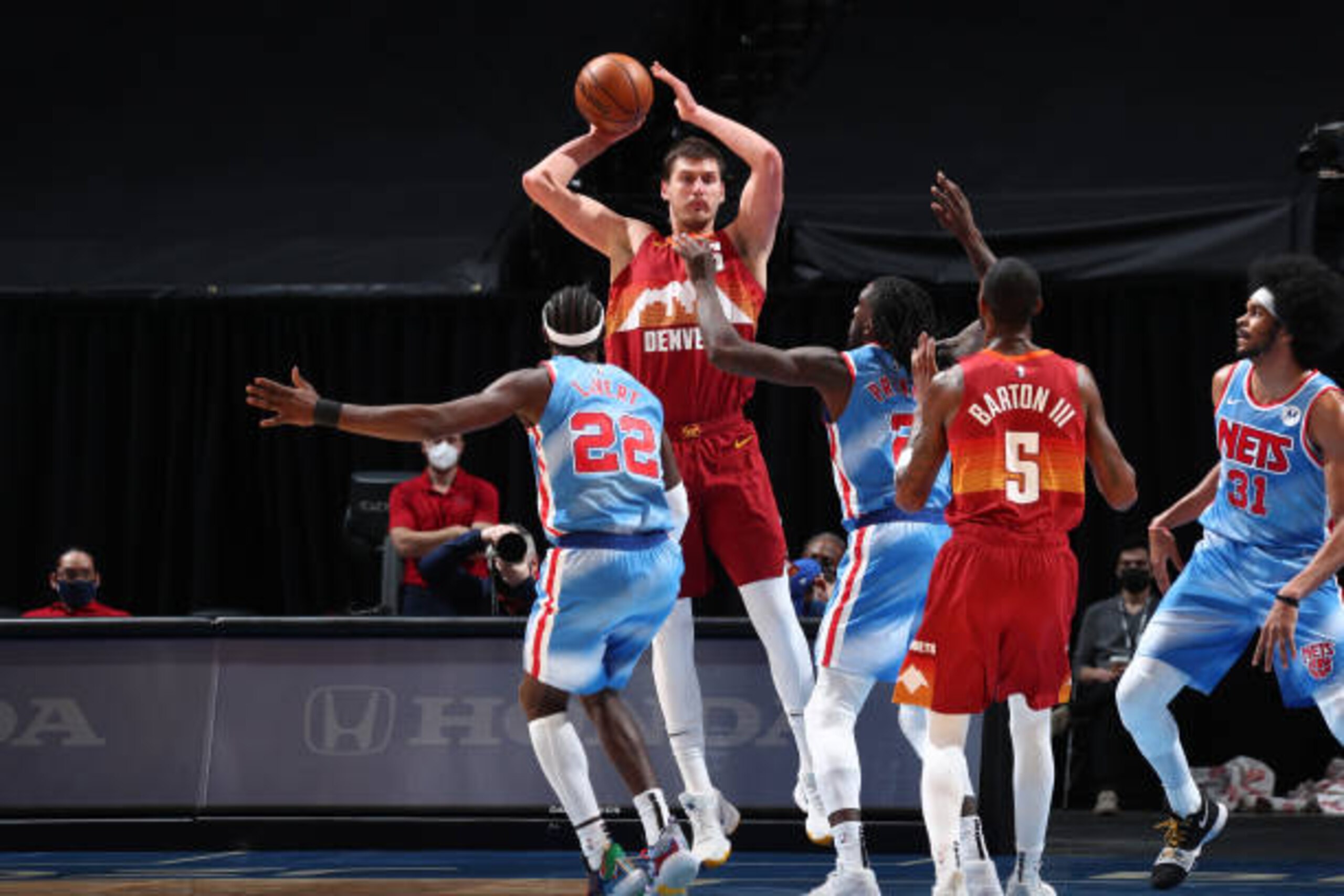 BROOKLYN, NY - JANUARY 12: Nikola Jokic #15 of the Denver Nuggets looks to pass the ball during the game against the Brooklyn Nets on January 12, 2021 at Barclays Center in Brooklyn, New York. NOTE TO USER: User expressly acknowledges and agrees that, by downloading and or using this Photograph, user is consenting to the terms and conditions of the Getty Images License Agreement. Mandatory Copyright Notice: Copyright 2021 NBAE (Photo by Nathaniel S. Butler/NBAE via Getty Images)