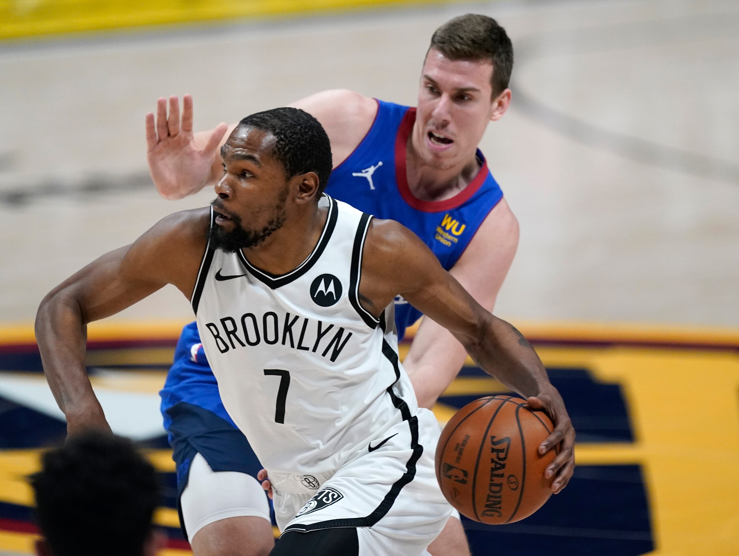 Brooklyn Nets forward Kevin Durant drives against Denver Nuggets forward Vlatko Cancar during the second half of an NBA basketball game Saturday, May 8, 2021, in Denver. (AP Photo/David Zalubowski)