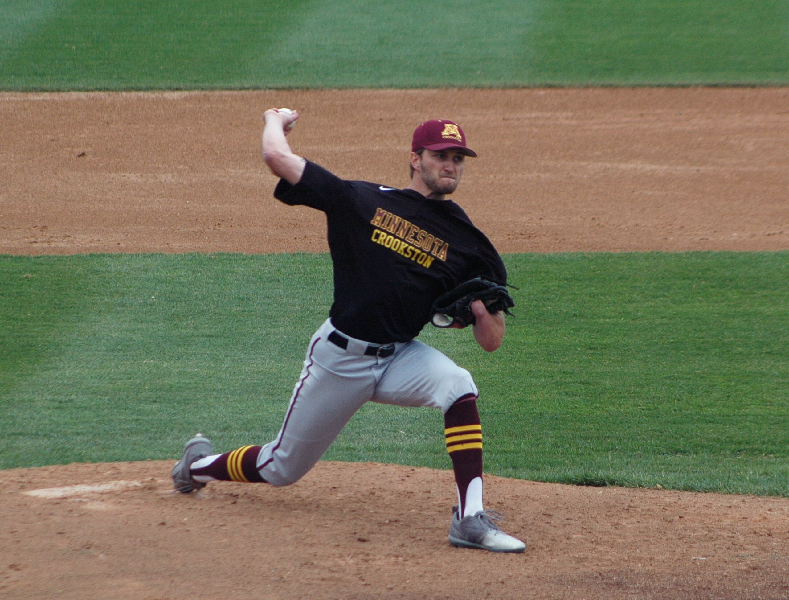 University of Minnesota-Crookston pitcher Parker Hanson throws against Minnesota State in St. Cloud, Minn., Wednesday, May 10, 2017. Hanson’s success could be measured in his 90-mph fastball, his nasty slider or his start that vaulted his college baseball team into the playoffs. Or it could be marked by what he’s missing.  Hanson was born without a left hand, but found a way to adapt at a young age so he could pitch, field, bat and play the game he loved. (AP Photo/Jeff Baenen)