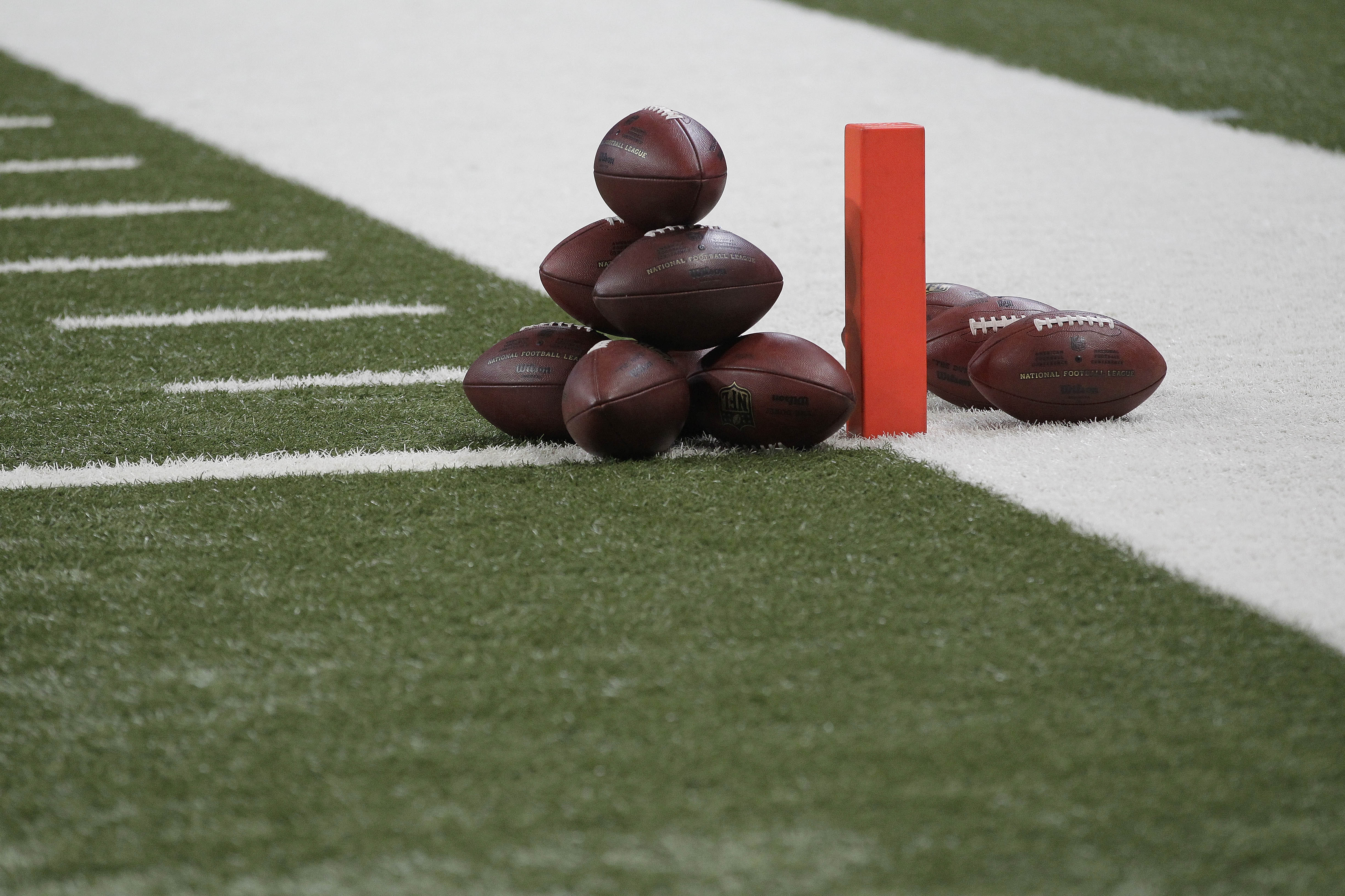 A stack of footballs are seen on the field before the start of an NFL football game between the St. Louis Rams and the Washington Redskins Sunday, Sept. 16, 2012, in St. Louis. (AP Photo/Seth Perlman)