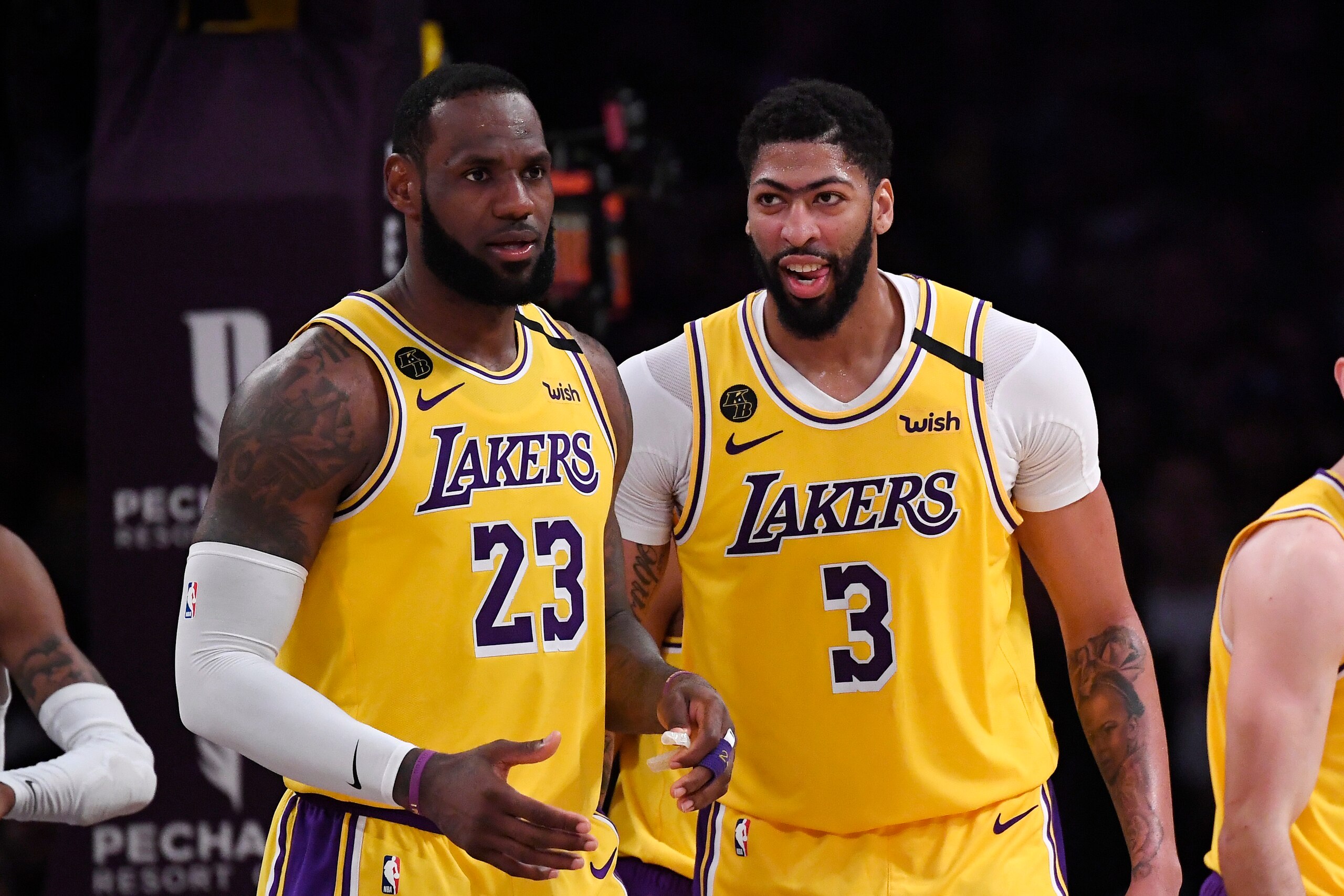 FILE - In this Feb. 21, 2020, file photo, Los Angeles Lakers forward LeBron James, left, stands with forward Anthony Davis during the second half of an NBA basketball game against the Memphis Grizzlies in Los Angeles. James and Davis had the Lakers on course to contend for another NBA title before the coronavirus pandemic upended their first season together. The superstars see no reason they can’t continue their quest in Orlando, and Davis even thinks the Lakers’ chances have improved.(AP Photo/Mark J. Terrill, File)