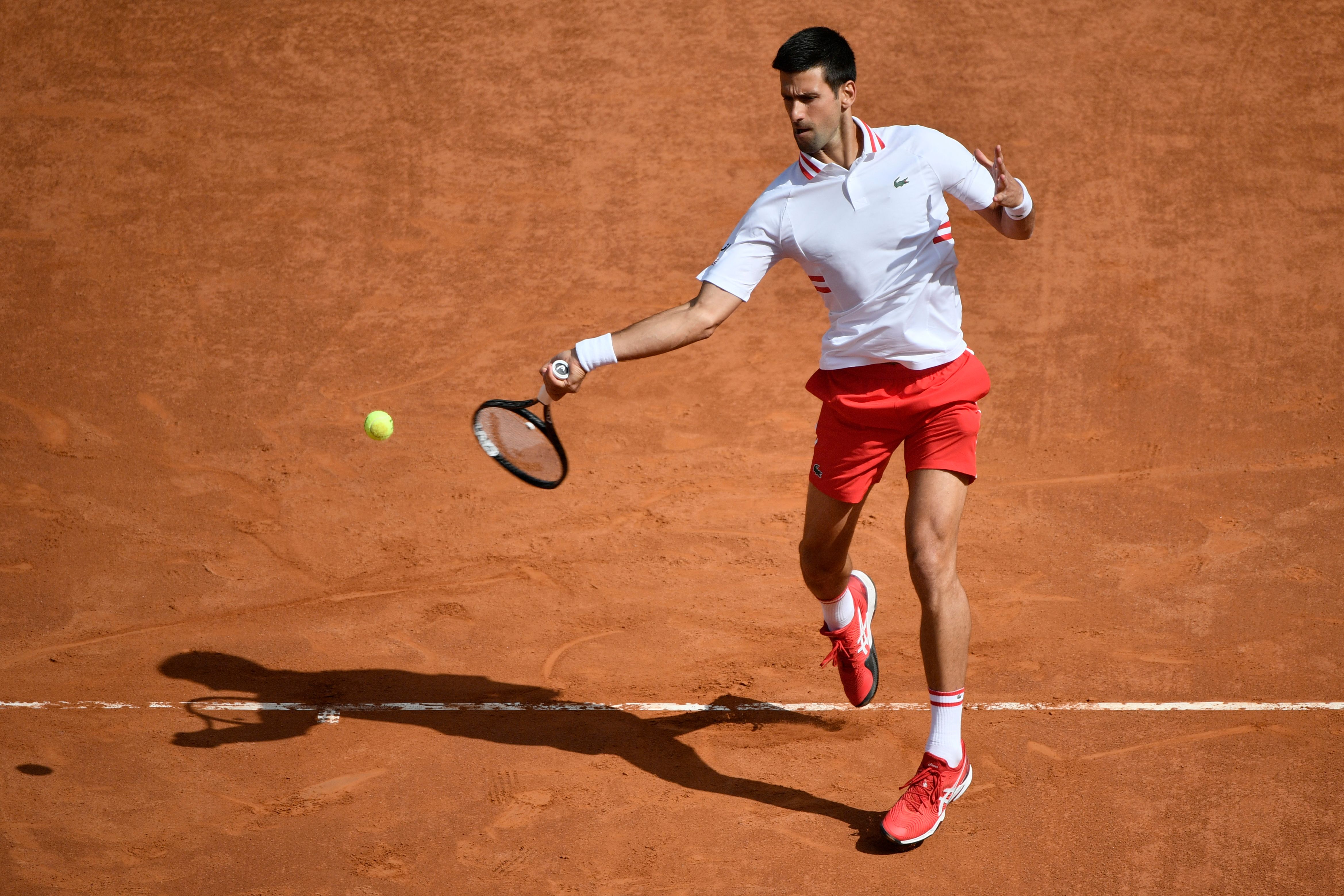 Serbia's Novak Djokovic returns a forehand to Spain's Alejandro Davidovich during their match of the Men's Italian Open at Foro Italico on May 13, 2021 in Rome, Italy. (Photo by Filippo MONTEFORTE / AFP) (Photo by FILIPPO MONTEFORTE/AFP via Getty Images)