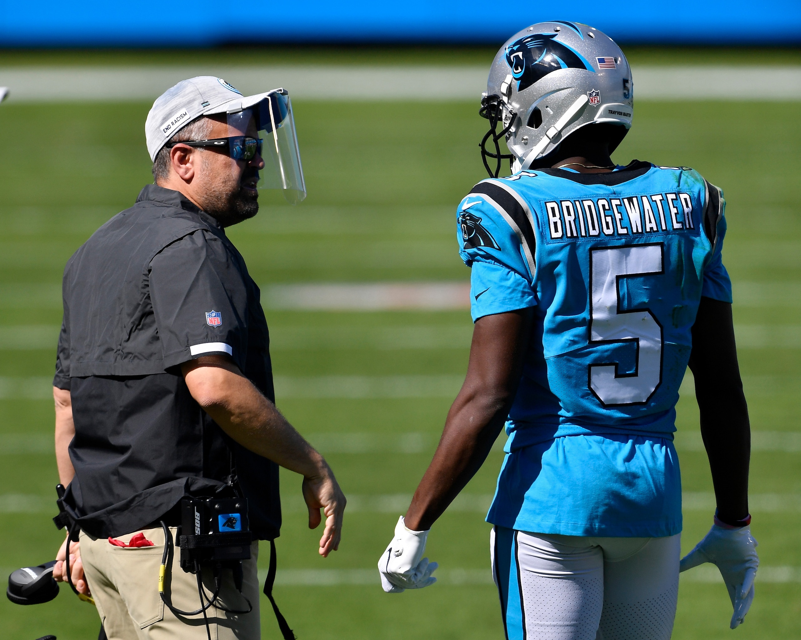 CHARLOTTE, NORTH CAROLINA - OCTOBER 18: Head coach Matt Rhule of the Carolina Panthers meets with Teddy Bridgewater #5 in the second quarter against the Chicago Bears at Bank of America Stadium on October 18, 2020 in Charlotte, North Carolina. (Photo by Grant Halverson/Getty Images)