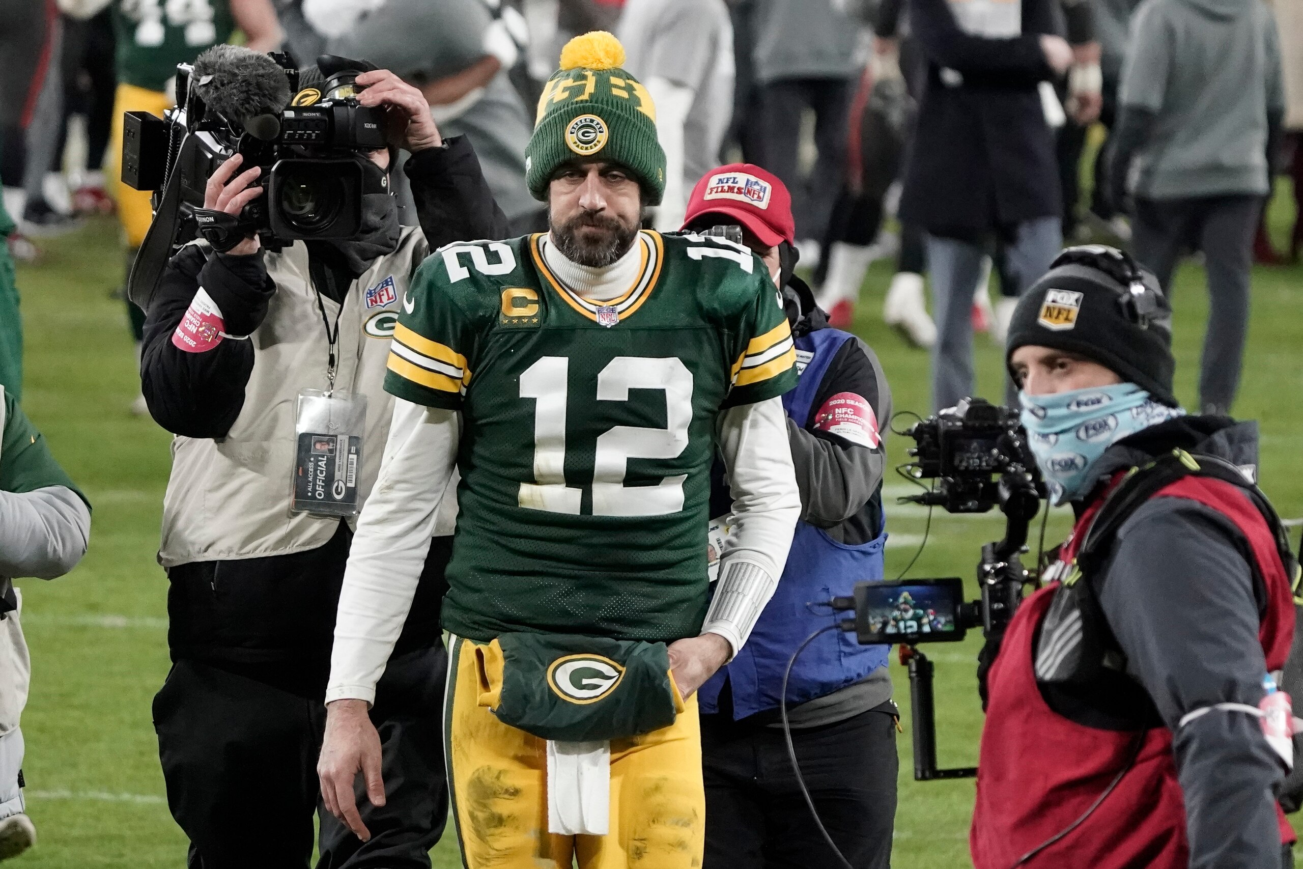 Green Bay Packers quarterback Aaron Rodgers (12) walks off the field after the NFC championship NFL football game against the Tampa Bay Buccaneers in Green Bay, Wis., Sunday, Jan. 24, 2021. The Buccaneers defeated the Packers 31-26 to advance to the Super Bowl. (AP Photo/Morry Gash)