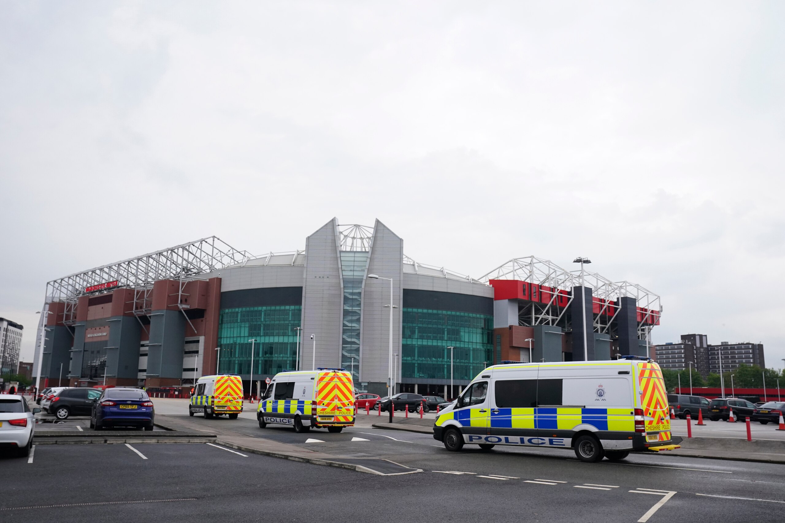 Police vans arrive ahead of any possible Manchester United fan protests against the Glazer family, the American owners of Manchester United, before their English Premier League soccer match against Liverpool at Old Trafford stadium in Manchester, England, Thursday, May 13, 2021. (AP Photo/Dave Thompson)