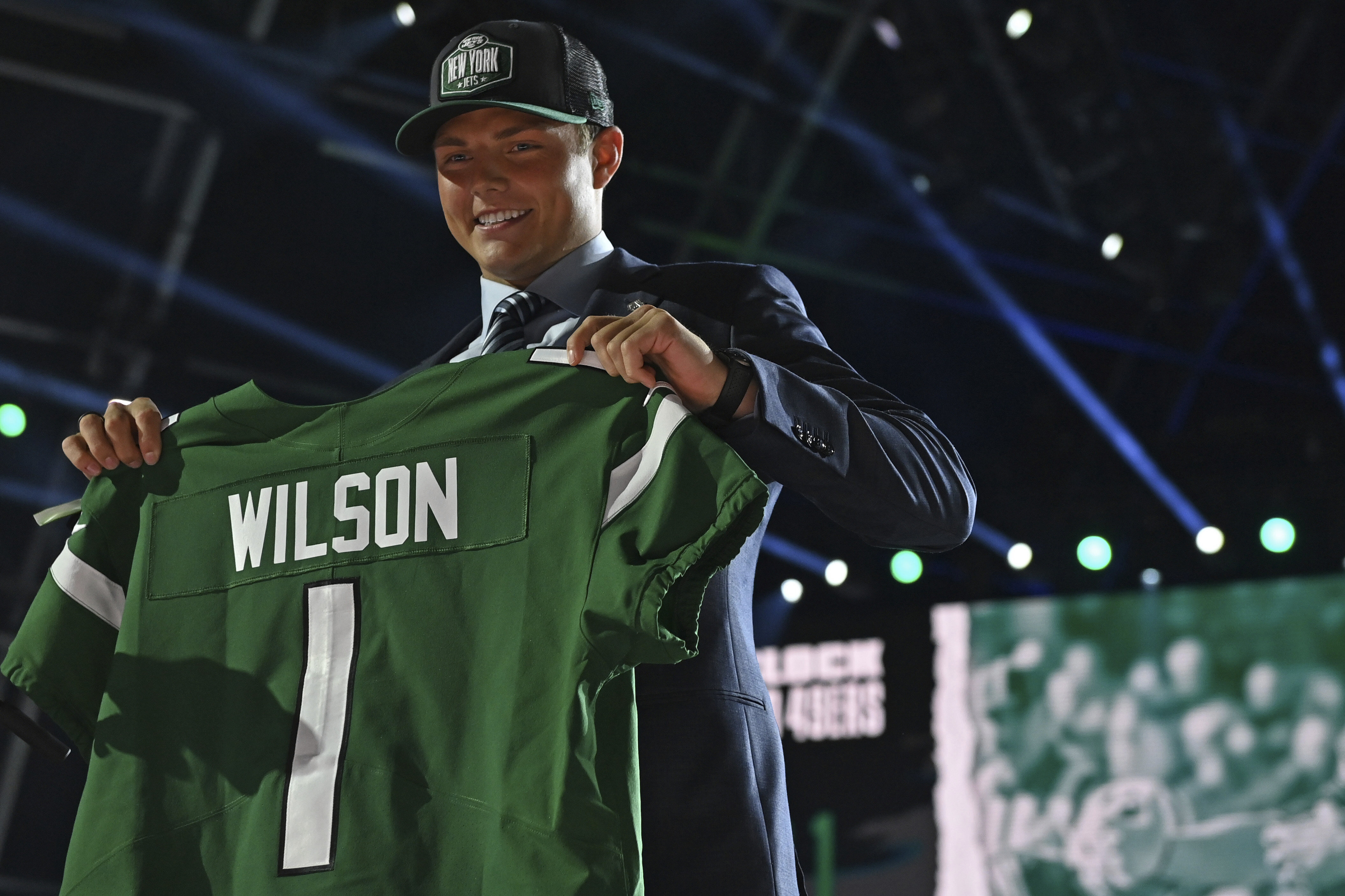 BYU quarterback Zach Wilson holds a team jersey after the New York Jets selected Wilson with the second pick in the first round of the NFL football draft Thursday April 29, 2021, in Cleveland. (AP Photo/David Dermer)