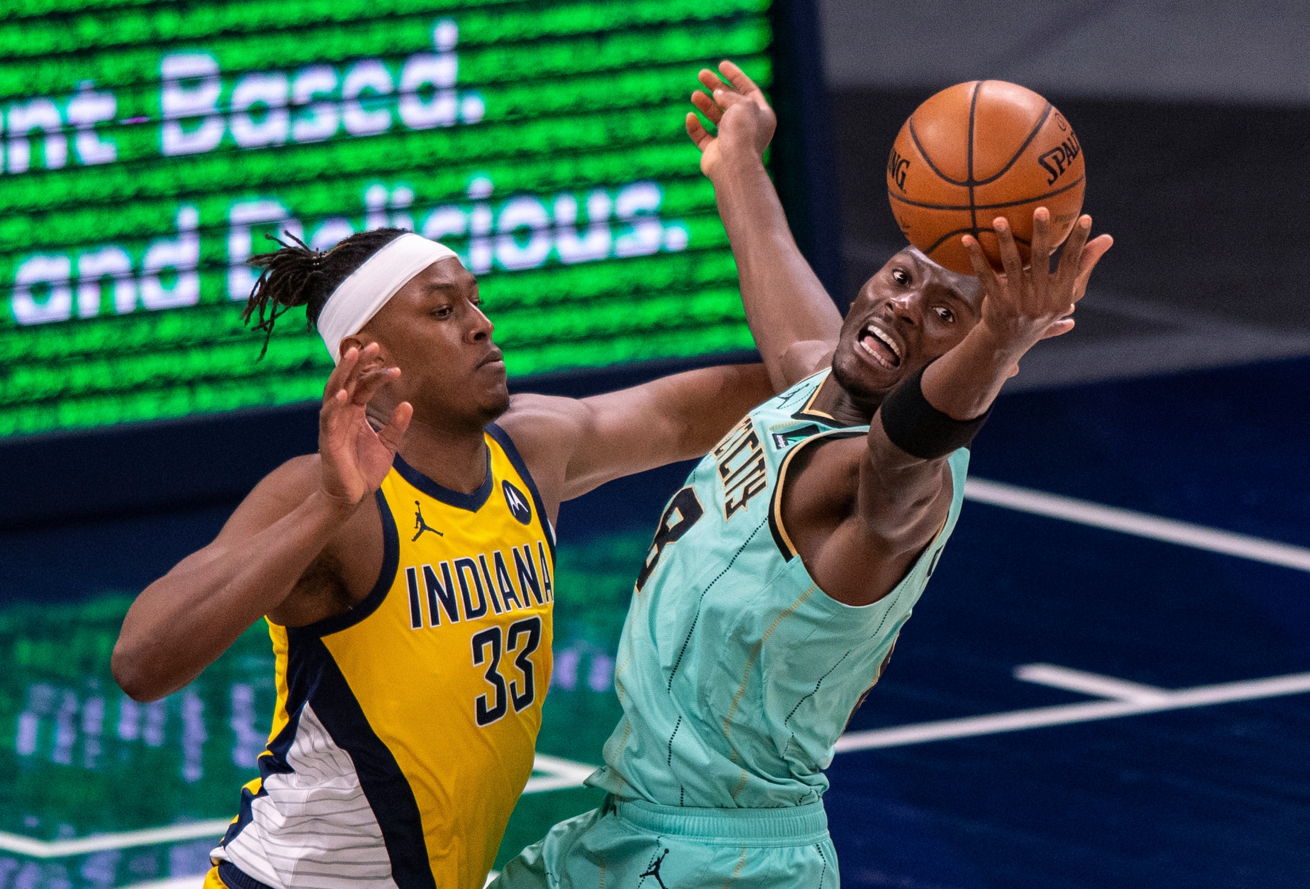 Charlotte Hornets center Bismack Biyombo (8) tries to gain control of a rebound while Indiana Pacers center Myles Turner (33) defends during the second half of an NBA basketball game in Indianapolis, Friday, April 2, 2021. (AP Photo/Doug McSchooler) Charlotte Hornets center Bismack Biyombo (8) tries to gain control of a rebound while Indiana Pacers center Myles Turner (33) defends during the second half of an NBA basketball game in Indianapolis, Friday, April 2, 2021. (AP Photo/Doug McSchooler)