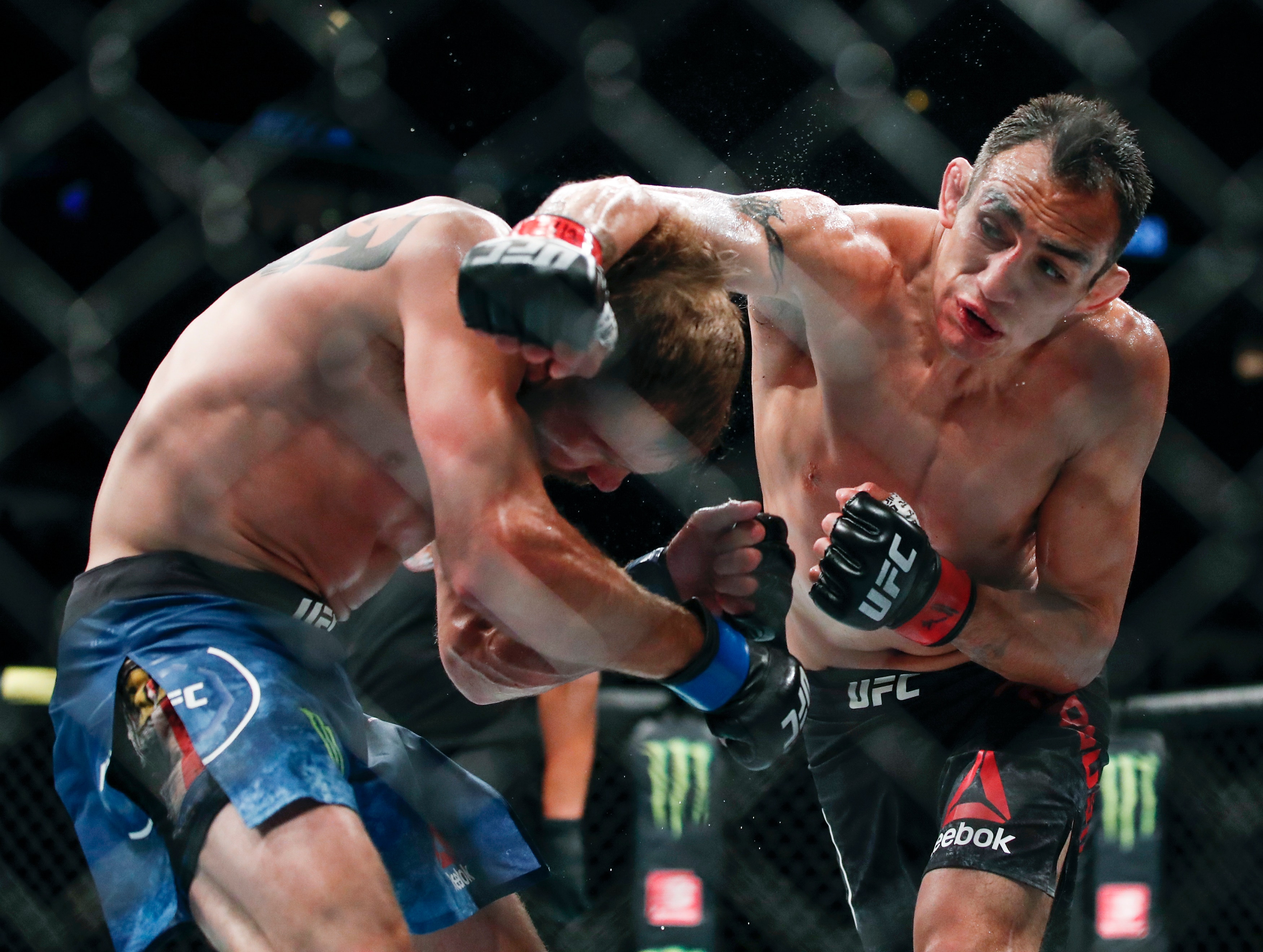 ARCHIVO - En imagen de archivo del 8 de junio de 2019, Tony Ferguson, derecha, falla un golpe lanzado a Donald Cerrone, izquierda, durante su combate en el evento UFC 238 en Chicago. (AP Foto/Kamil Krzaczynski, archivo)