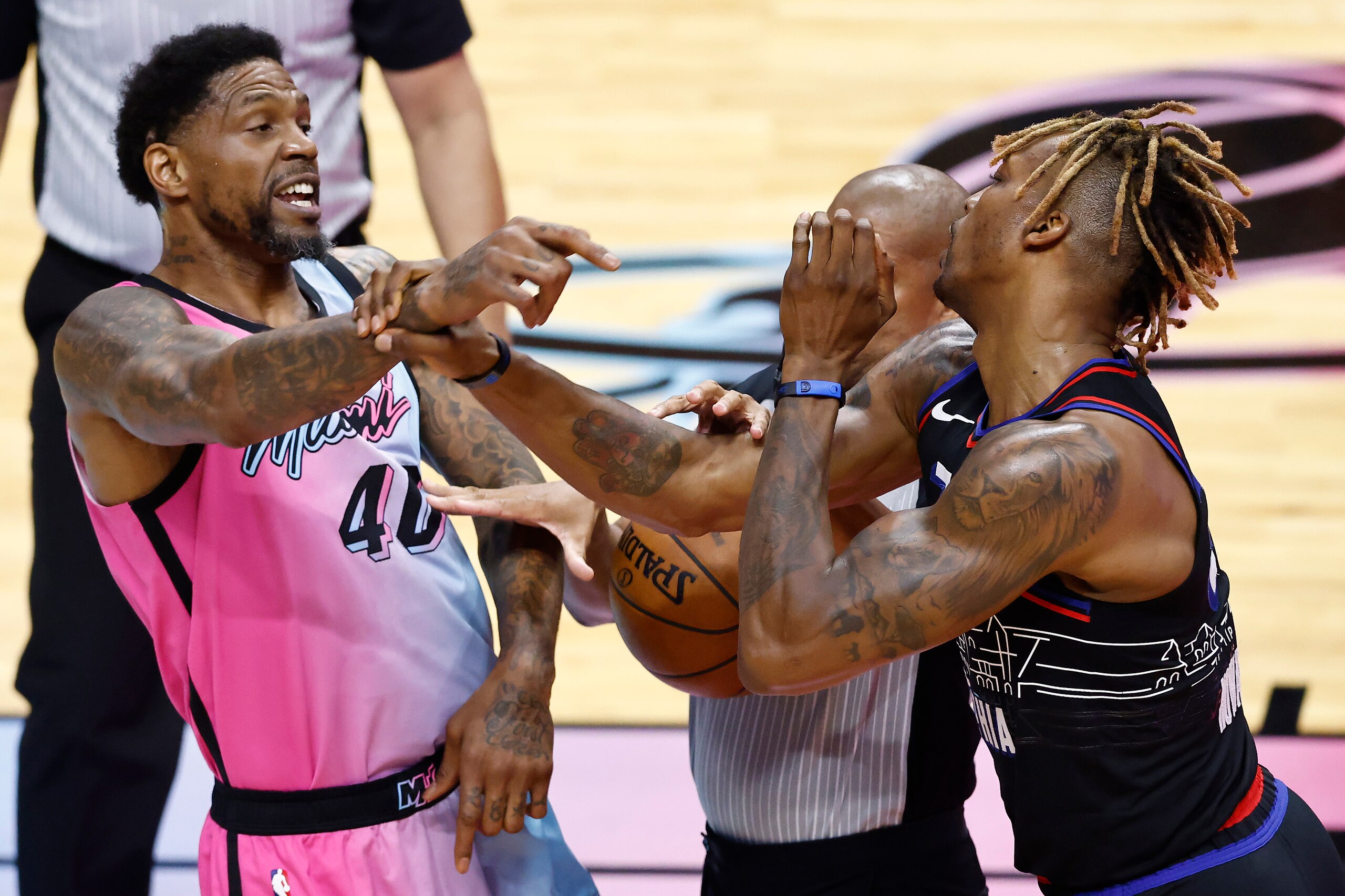 MIAMI, FLORIDA - MAY 13: Udonis Haslem #40 of the Miami Heat and Dwight Howard #39 of the Philadelphia 76ers are broken up by referee Sean Corbin #33 while being involved in a scuffle during the second quarter at American Airlines Arena on May 13, 2021 in Miami, Florida. NOTE TO USER: User expressly acknowledges and agrees that, by downloading and or using this photograph, User is consenting to the terms and conditions of the Getty Images License Agreement. (Photo by Michael Reaves/Getty Images)