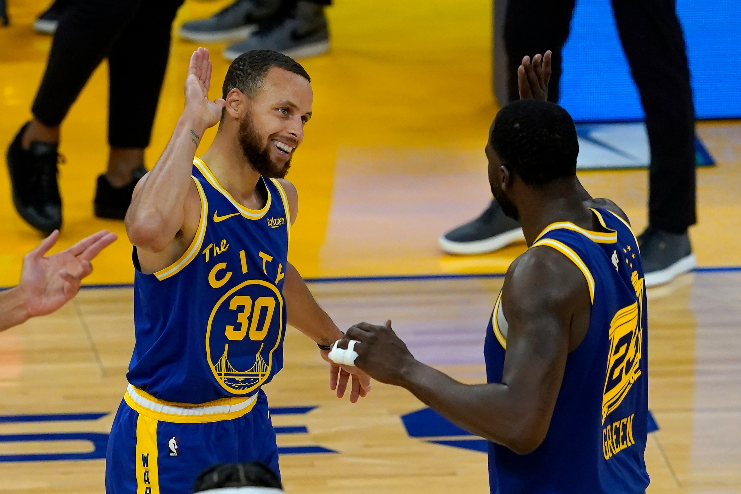 Golden State Warriors guard Stephen Curry (30) celebrates with forward Draymond Green during the second half of an NBA basketball game against the Utah Jazz in San Francisco, Monday, May 10, 2021. (AP Photo/Jeff Chiu)