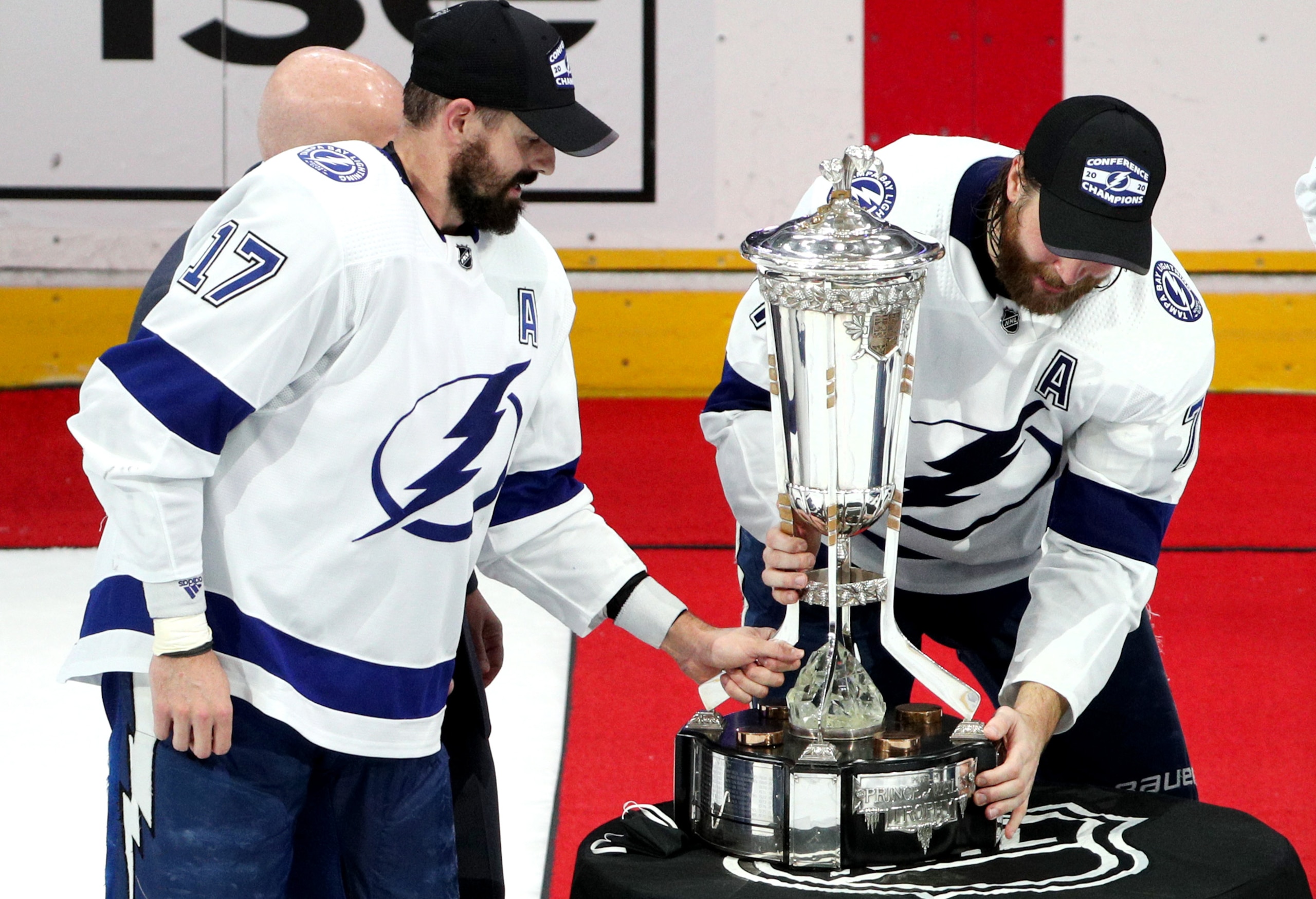 EDMONTON, ALBERTA - SEPTEMBER 17: Alex Killorn #17 of the Tampa Bay Lightning and teammate Victor Hedman #77 touch the Prince of Wales Trophy after the Lightning won 2-1 in the first overtime period of Game Six of the Eastern Conference Final of the 2020 NHL Stanley Cup Playoffs between the Tampa Bay Lightning and the New York Islanders at Rogers Place on September 17, 2020 in Edmonton, Alberta. The Lightning defeated the Islanders 2-1 in overtime of game six to take the best of seven game series 4-2. (Photo by Dave Sandford/NHLI via Getty Images)