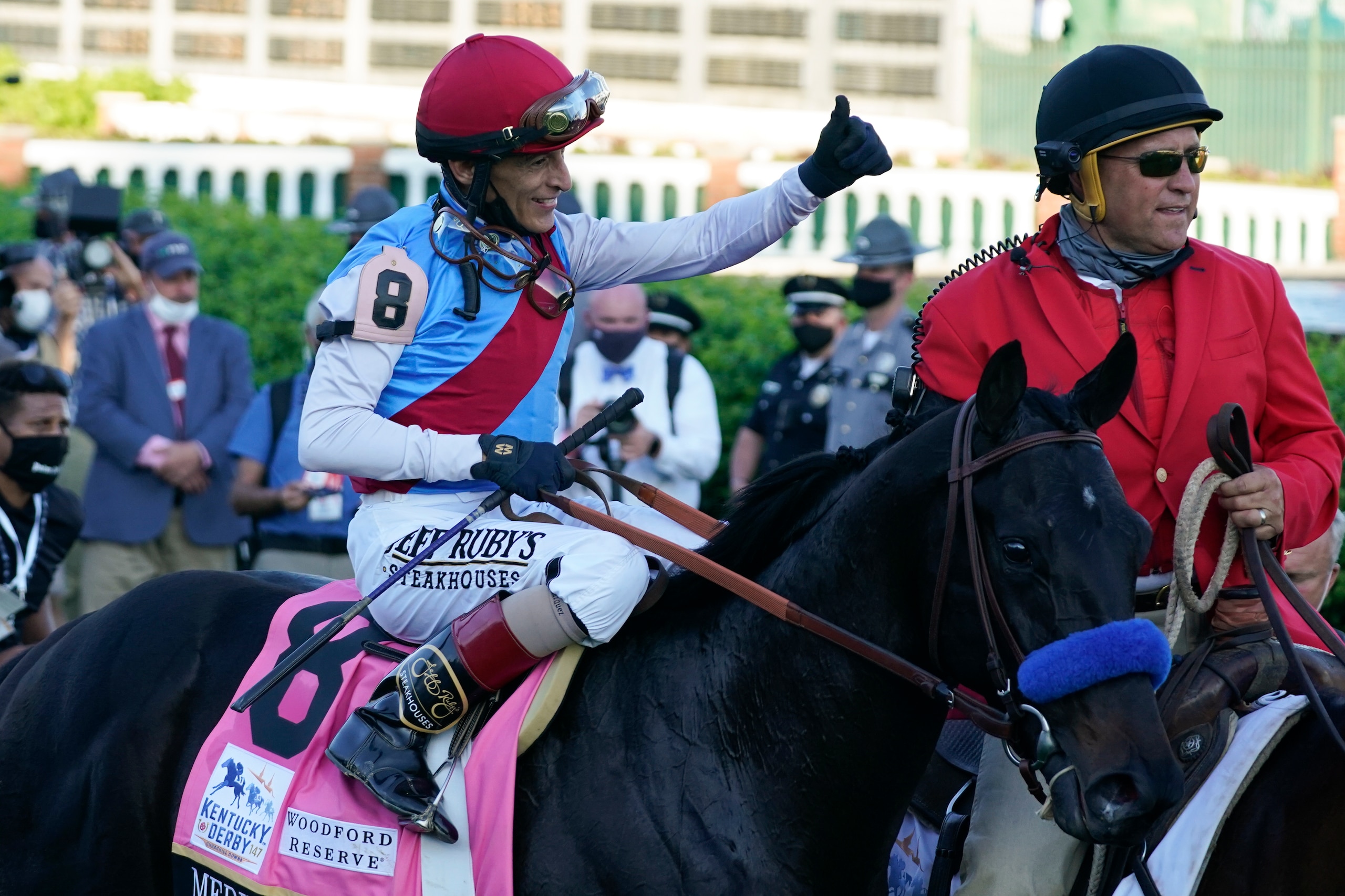 Jockey John Velazquez onboard Medina Spirit gives a thumbs up after winning the 147th running of the Kentucky Derby at Churchill Downs, Saturday, May 1, 2021, in Louisville, Ky. (AP Photo/Brynn Anderson)