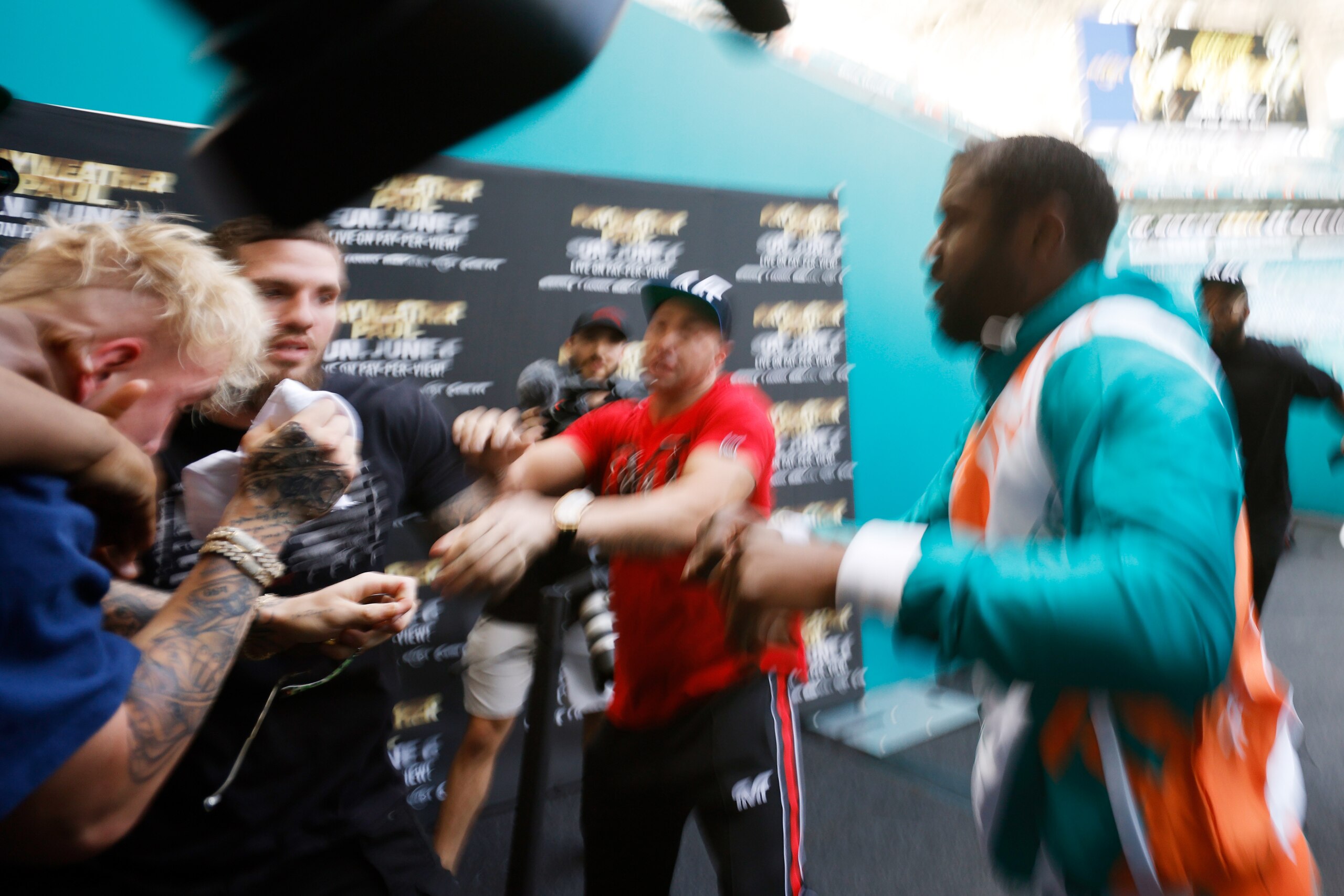MIAMI GARDENS, FLORIDA - MAY 06: Floyd Mayweather and Jake Paul scuffle after Paul took Mayweather's hat during a media availability for Mayweather's fight against Logan Paul, brother of Jake Paul, at Hard Rock Stadium on May 06, 2021 in Miami Gardens, Florida. (Photo by Cliff Hawkins/Getty Images) MIAMI GARDENS, FLORIDA - MAY 06: Floyd Mayweather and Jake Paul scuffle after Paul took Mayweather's hat during a media availability for Mayweather's fight against Logan Paul, brother of Jake Paul, at Hard Rock Stadium on May 06, 2021 in Miami Gardens, Florida. (Photo by Cliff Hawkins/Getty Images)