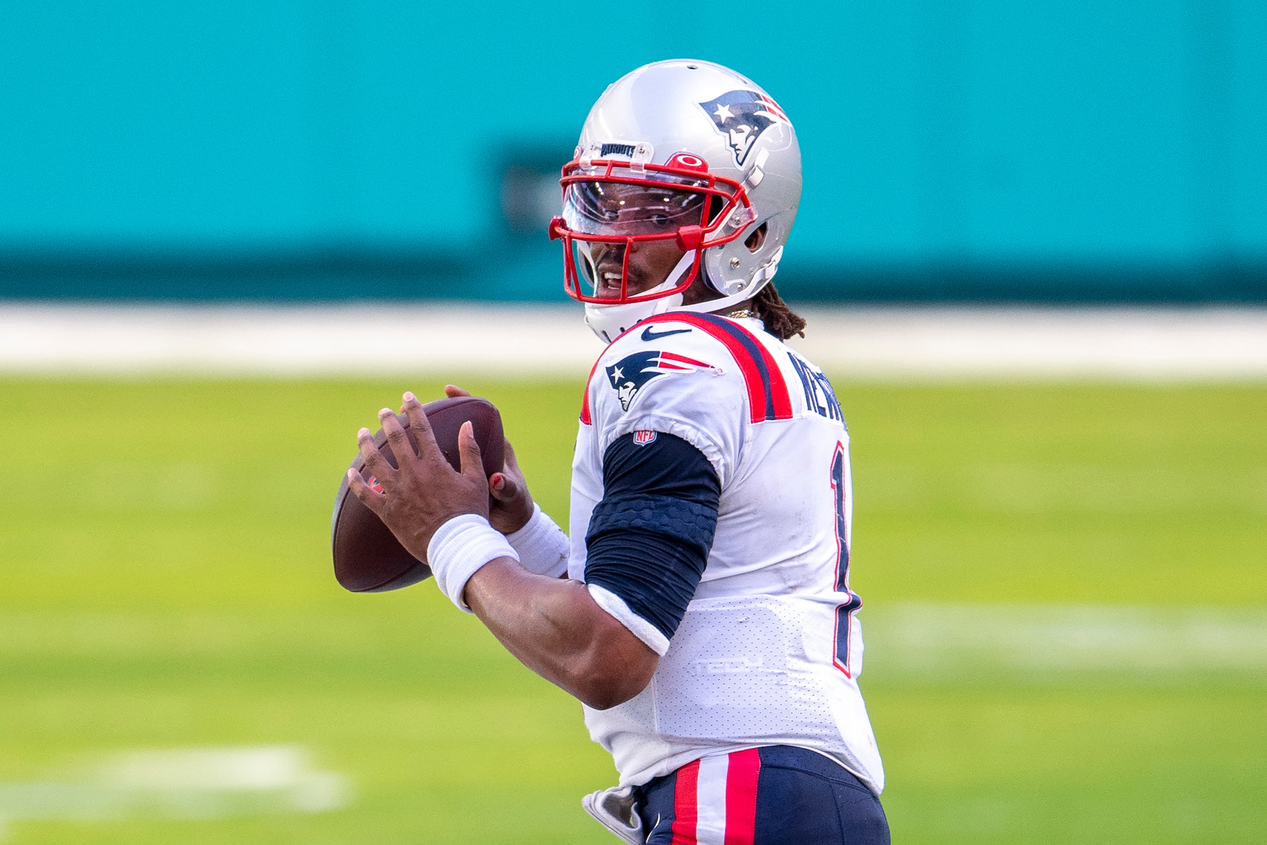 FILE - New England Patriots quarterback Cam Newton (1) looks to throw the ball against the Miami Dolphins during an NFL football game in Miami Gardens, Fla., in this Sunday, Dec. 20, 2020, file photo. Washington’s biggest offseason need is to figure out its quarterback situation. Trade for DeShaun Watson? Sign Cam Newton? Roll with Alex Smith and Kyle Allen? Coach Ron Rivera says “nothing is off the table.” (AP Photo/Doug Murray, File)