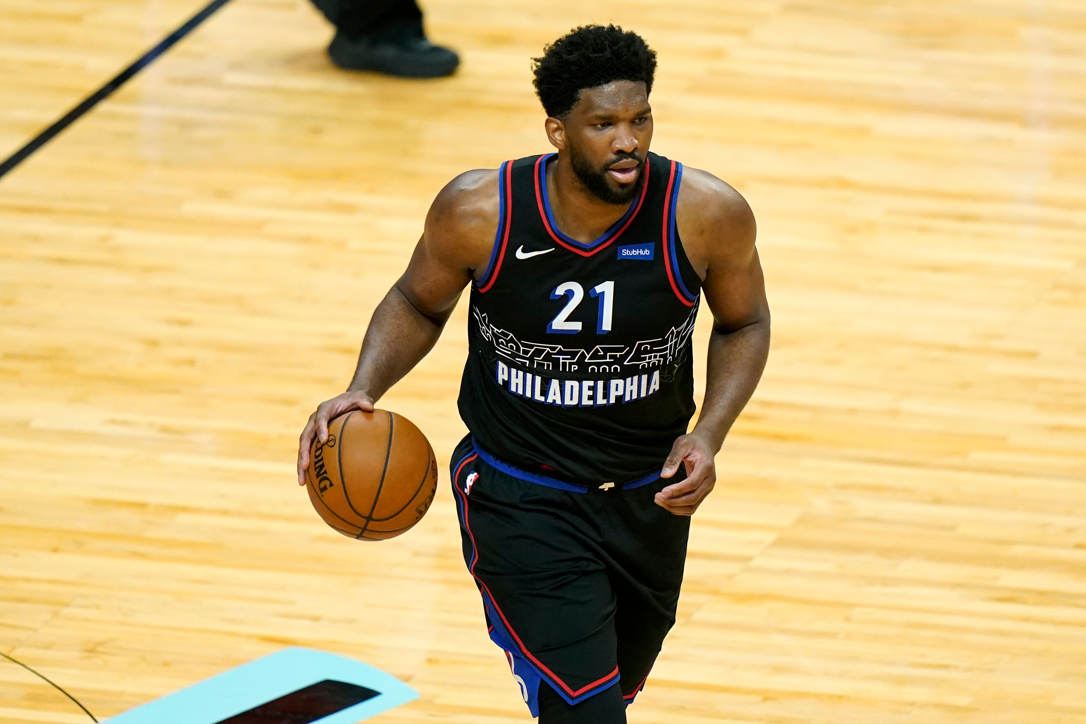 Philadelphia 76ers center Joel Embiid (21) moves the ball down the court during the first half of an NBA basketball game against the Miami Heat, Thursday, May 13, 2021, in Miami. (AP Photo/Lynne Sladky)
