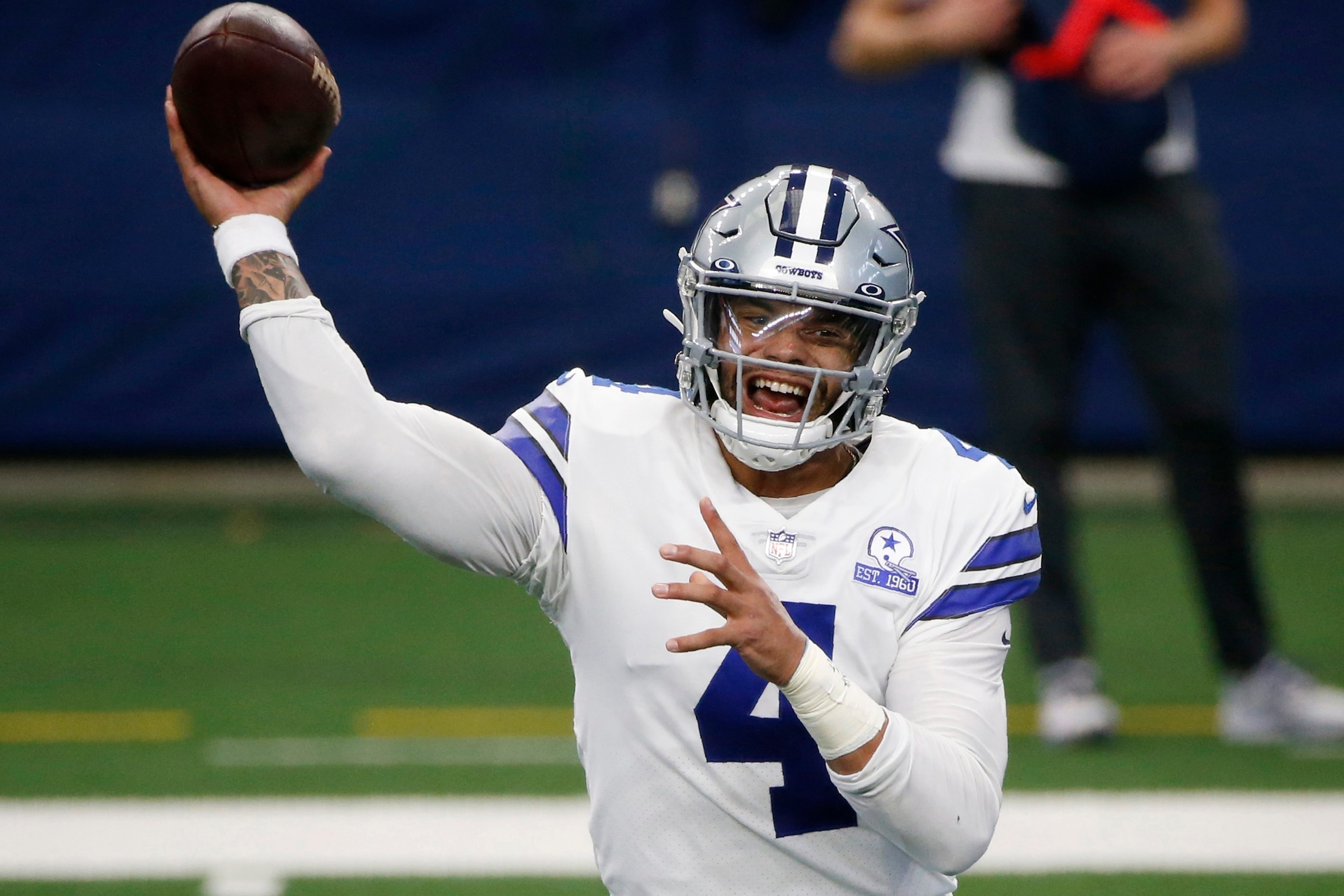FILE - In this Oct. 11, 2020, file photo, Dallas Cowboys quarterback Dak Prescott throws a pass in the first half of an NFL football game against the New York Giants in Arlington, Texas. The NFL is returning to London in October and Tom Brady begins his pursuit of an eighth Super Bowl title against Dak Prescott and the Dallas Cowboys when Tampa Bay hosts the league’s annual kickoff game on Sept. 9. (AP Photo/Michael Ainsworth, File)