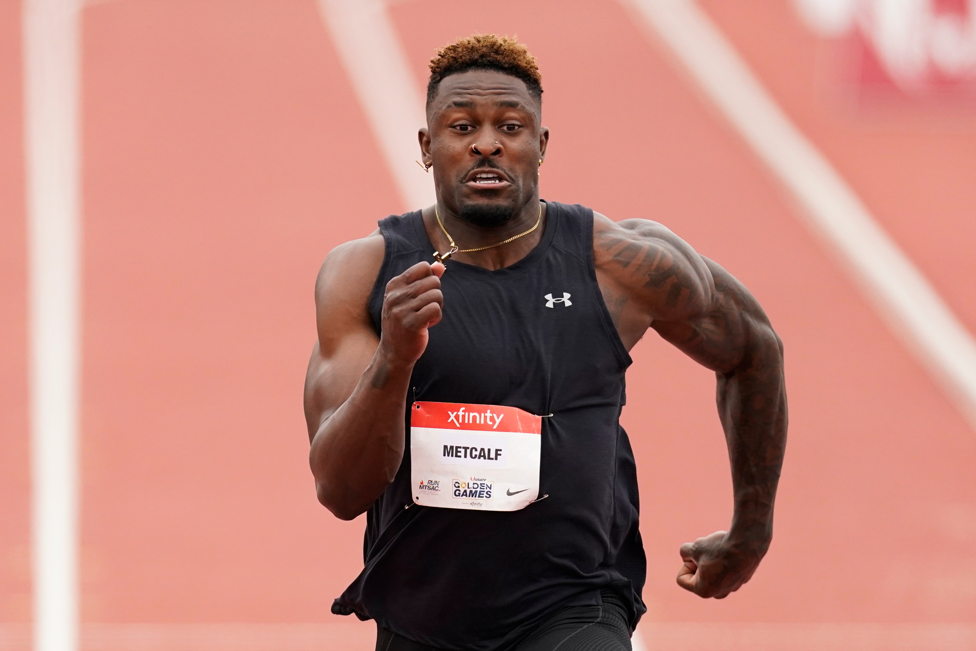 Seattle Seahawks wide receiver DK Metcalf competes in the second heat of the men's 100-meter dash prelim during the USATF Golden Games at Mt. San Antonio College Sunday, May 9, 2021, in Walnut, Calif. (AP Photo/Ashley Landis)