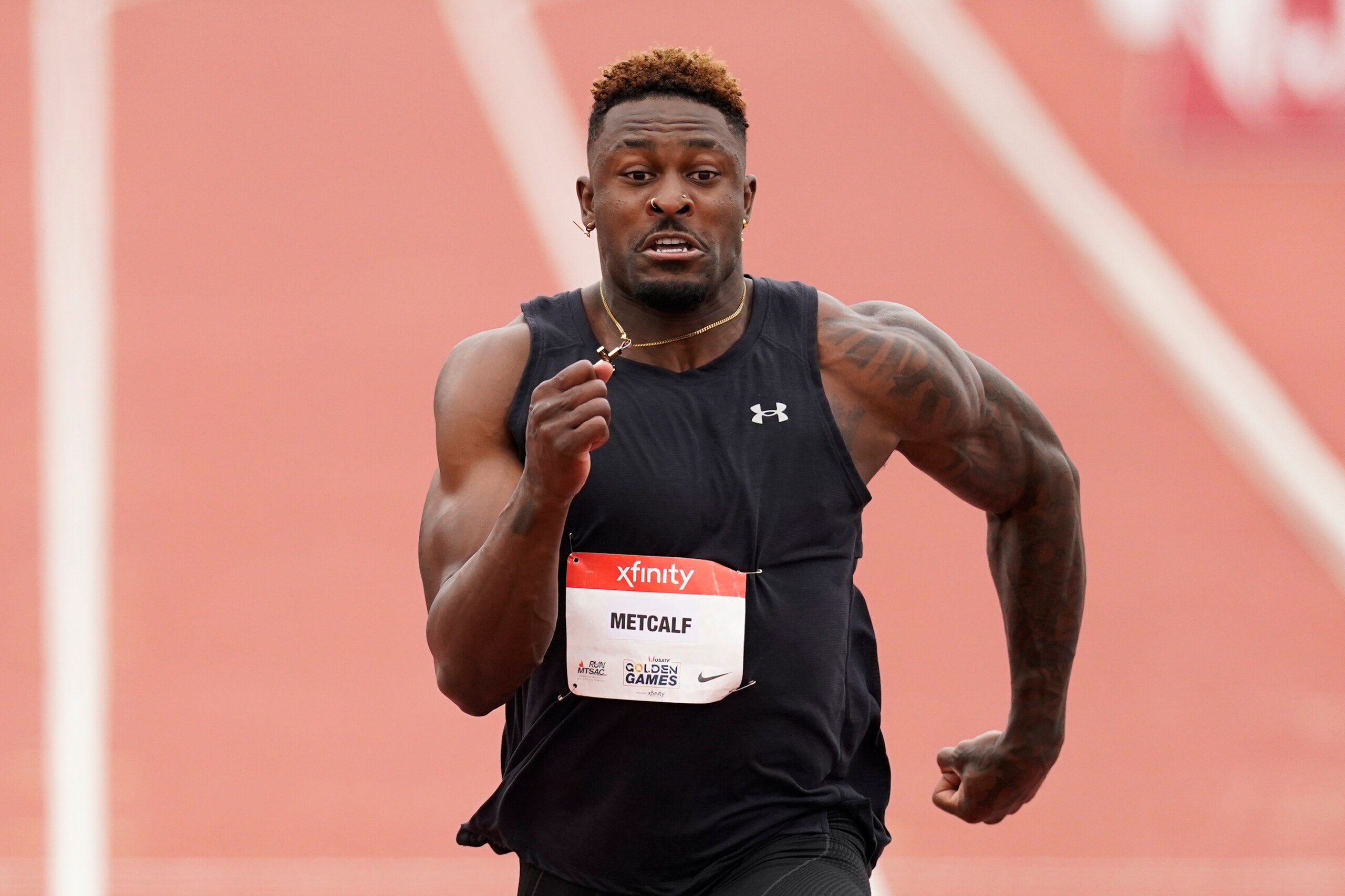 Seattle Seahawks wide receiver DK Metcalf competes in the second heat of the men's 100-meter dash prelim during the USATF Golden Games at Mt. San Antonio College Sunday, May 9, 2021, in Walnut, Calif. (AP Photo/Ashley Landis)