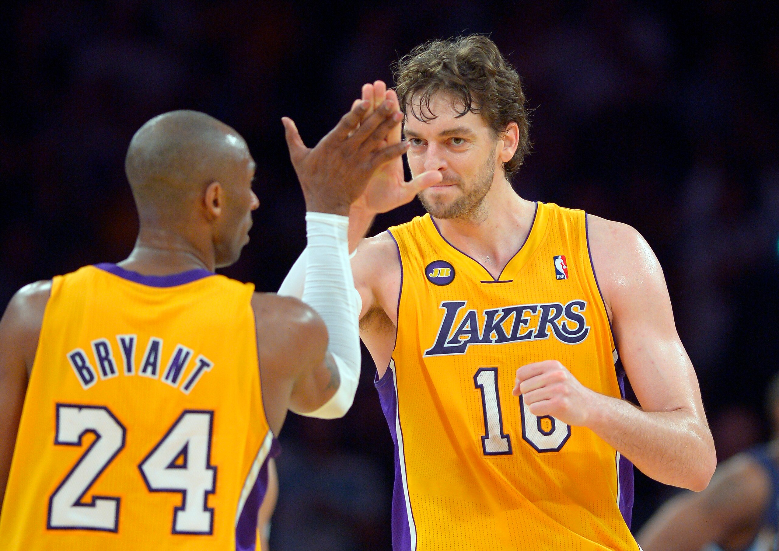 Los Angeles Lakers guard Kobe Bryant, left, is congratulated by forward Pau Gasol, of Spain, after he scored during the second half of their NBA basketball game, Friday, April 5, 2013, in Los Angeles. The Lakers won 86-84. (AP Photo/Mark J. Terrill)