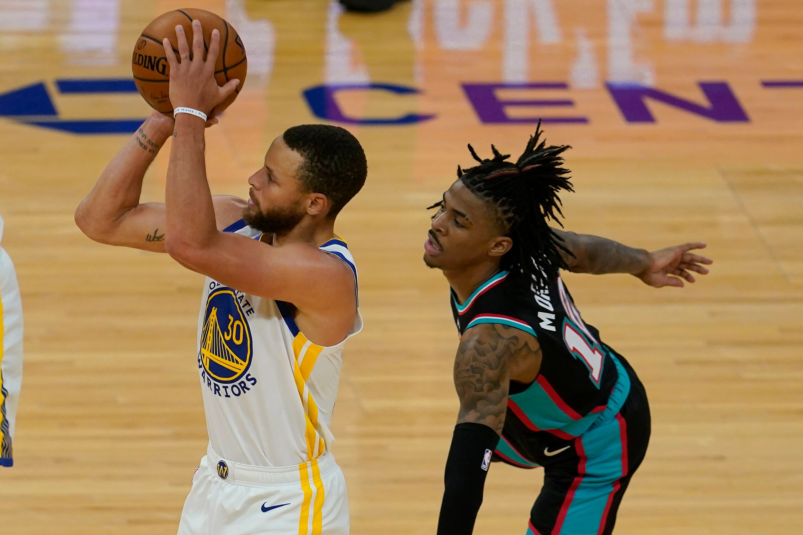 Golden State Warriors guard Stephen Curry (30) shoots a 3-point basket in front of Memphis Grizzlies guard Ja Morant during the second half of an NBA basketball game in San Francisco, Sunday, May 16, 2021. (AP Photo/Jeff Chiu) Golden State Warriors guard Stephen Curry (30) shoots a 3-point basket in front of Memphis Grizzlies guard Ja Morant during the second half of an NBA basketball game in San Francisco, Sunday, May 16, 2021. (AP Photo/Jeff Chiu)