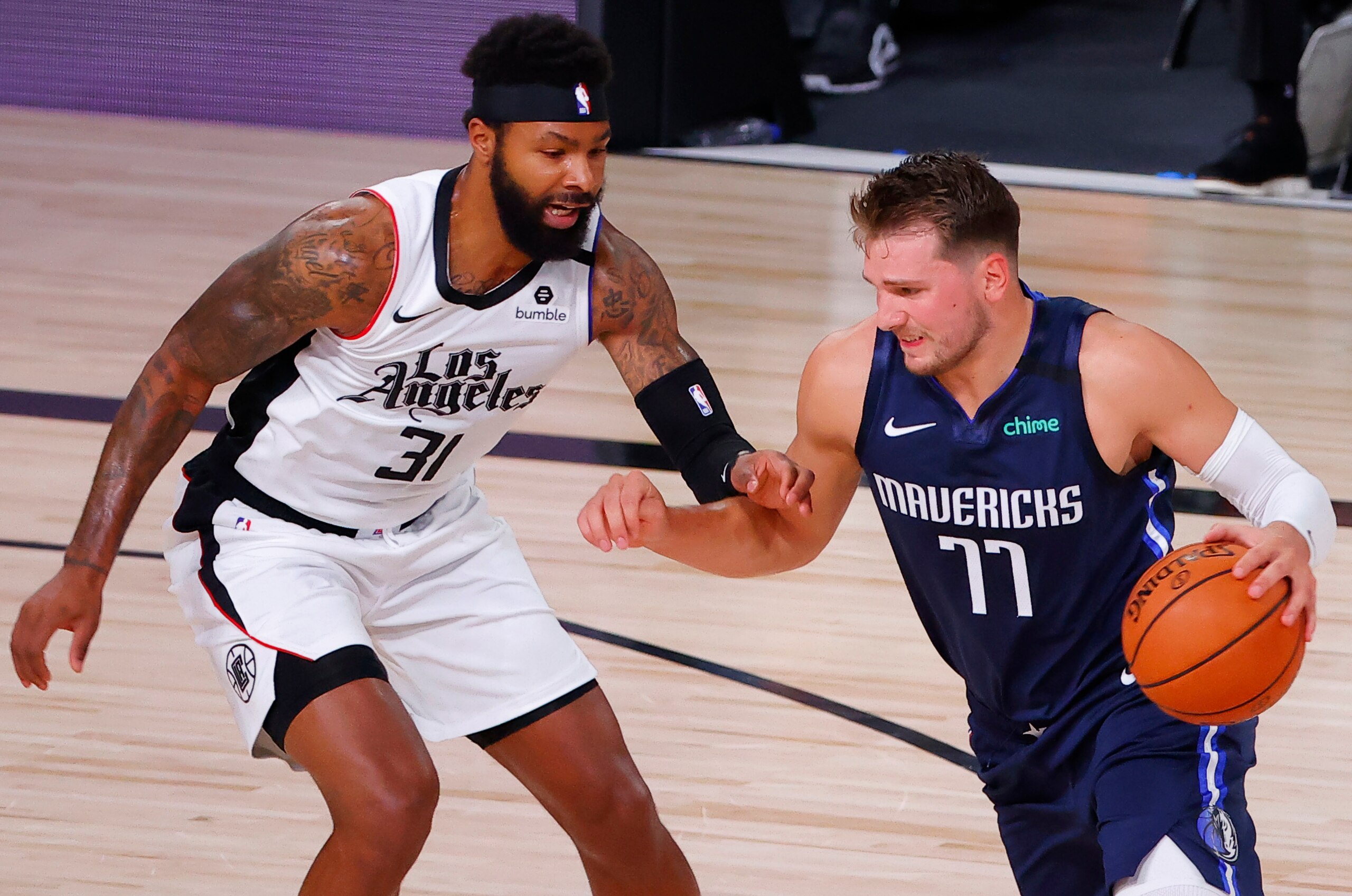 LAKE BUENA VISTA, FLORIDA - AUGUST 23: Luka Doncic #77 of the Dallas Mavericks drives against Marcus Morris Sr. #31 of the LA Clippers during the first quarter in Game Four of the Western Conference First Round during the 2020 NBA Playoffs at AdventHealth Arena at ESPN Wide World Of Sports Complex on August 23, 2020 in Lake Buena Vista, Florida. NOTE TO USER: User expressly acknowledges and agrees that, by downloading and or using this photograph, User is consenting to the terms and conditions of the Getty Images License Agreement. (Photo by Kevin C. Cox/Getty Images) LAKE BUENA VISTA, FLORIDA - AUGUST 23: Luka Doncic #77 of the Dallas Mavericks drives against Marcus Morris Sr. #31 of the LA Clippers during the first quarter in Game Four of the Western Conference First Round during the 2020 NBA Playoffs at AdventHealth Arena at ESPN Wide World Of Sports Complex on August 23, 2020 in Lake Buena Vista, Florida. NOTE TO USER: User expressly acknowledges and agrees that, by downloading and or using this photograph, User is consenting to the terms and conditions of the Getty Images License Agreement. (Photo by Kevin C. Cox/Getty Images)