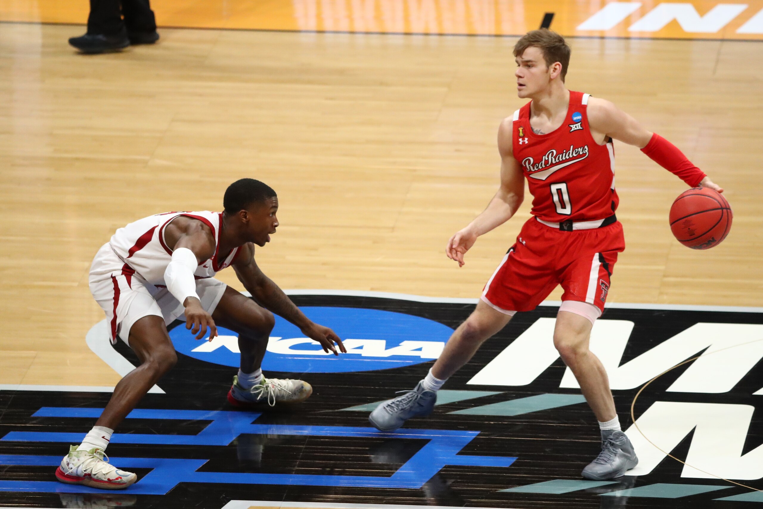 INDIANAPOLIS, IN - MARCH 21: Davonte Davis #4 of the Arkansas Razorbacks defends against Mac McClung #0 of the Texas Tech Red Raiders during the first half in the second round of the 2021 NCAA Division I Mens Basketball Tournament held at Hinkle Fieldhouse on March 21, 2021 in Indianapolis, Indiana. (Photo by C. Morgan Engel/NCAA Photos via Getty Images)
