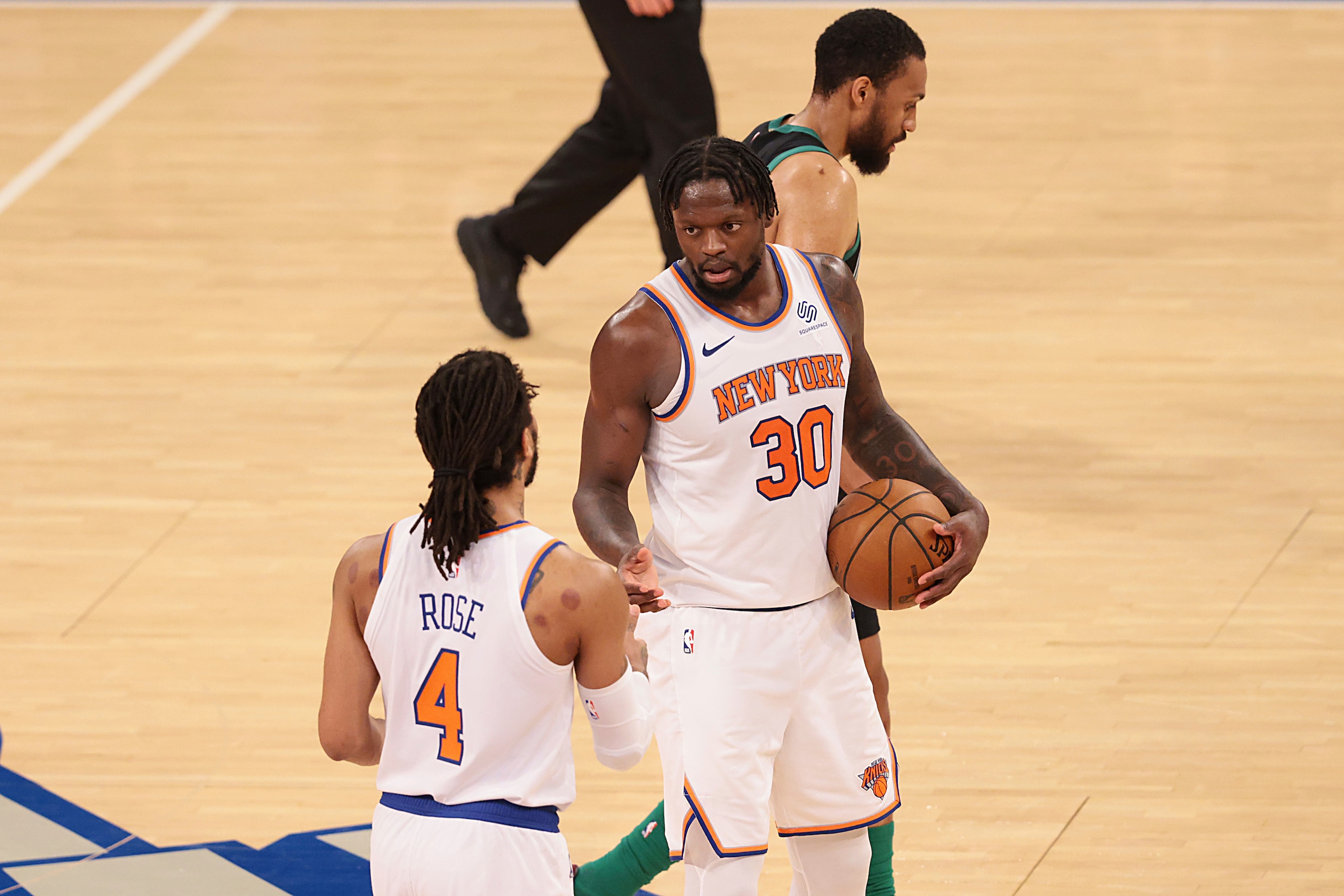 New York Knicks forward Julius Randle (30) celebrates with guard Derrick Rose (4) after an NBA basketball  game against the Boston Celtics in New York, Sunday, May 16, 2021. (Vincent Carchietta/Pool Photo via AP)