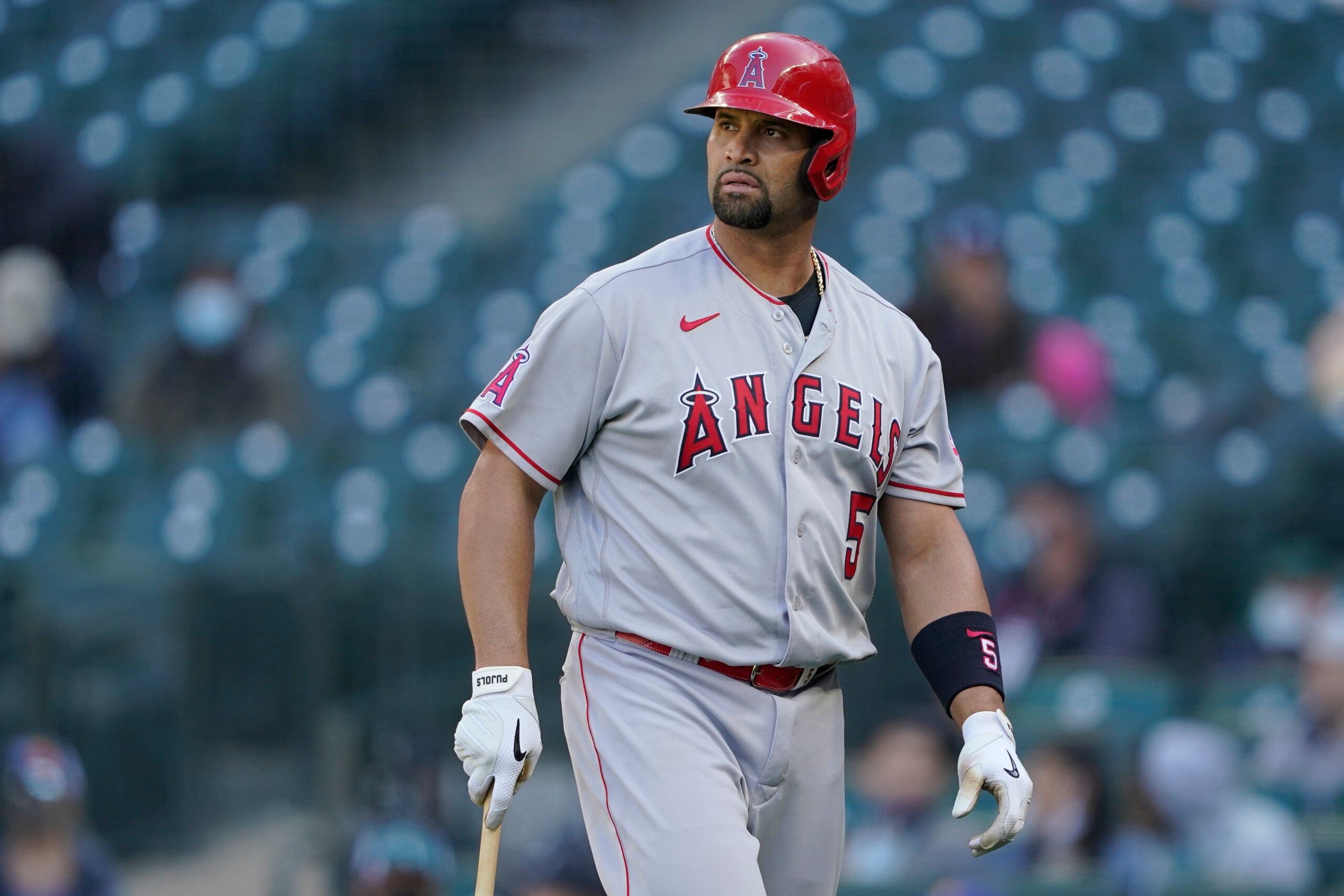 Los Angeles Angels Albert Pujols walks to the dugout after he was called out on strikes during the ninth inning of a baseball game against the Seattle Mariners, Sunday, May 2, 2021, in Seattle. (AP Photo/Ted S. Warren) Los Angeles Angels Albert Pujols walks to the dugout after he was called out on strikes during the ninth inning of a baseball game against the Seattle Mariners, Sunday, May 2, 2021, in Seattle. (AP Photo/Ted S. Warren)