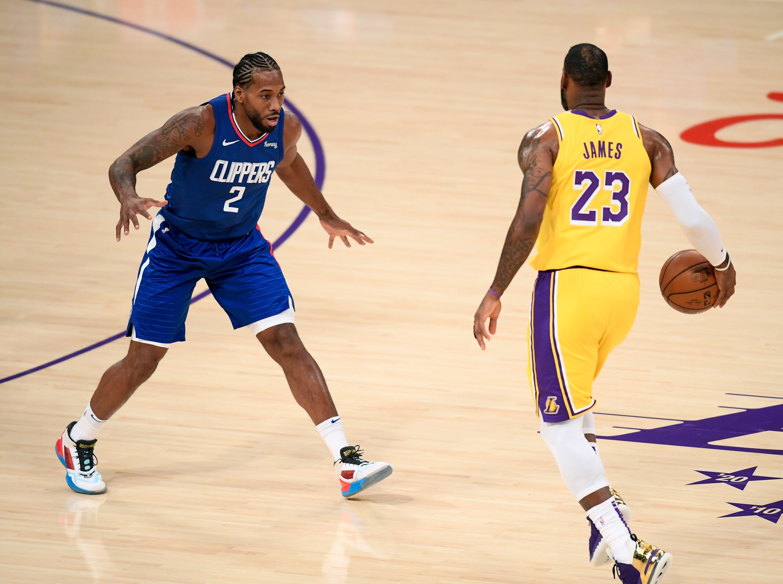 LOS ANGELES, CALIFORNIA - DECEMBER 22:  Kawhi Leonard #2 of the LA Clippers guards LeBron James #23 of the Los Angeles Lakers during the season opening game at Staples Center on December 22, 2020 in Los Angeles, California. NOTE TO USER: User expressly acknowledges and agrees that, by downloading and or using this photograph, User is consenting to the terms and conditions of the Getty Images License Agreement. (Photo by Harry How/Getty Images)