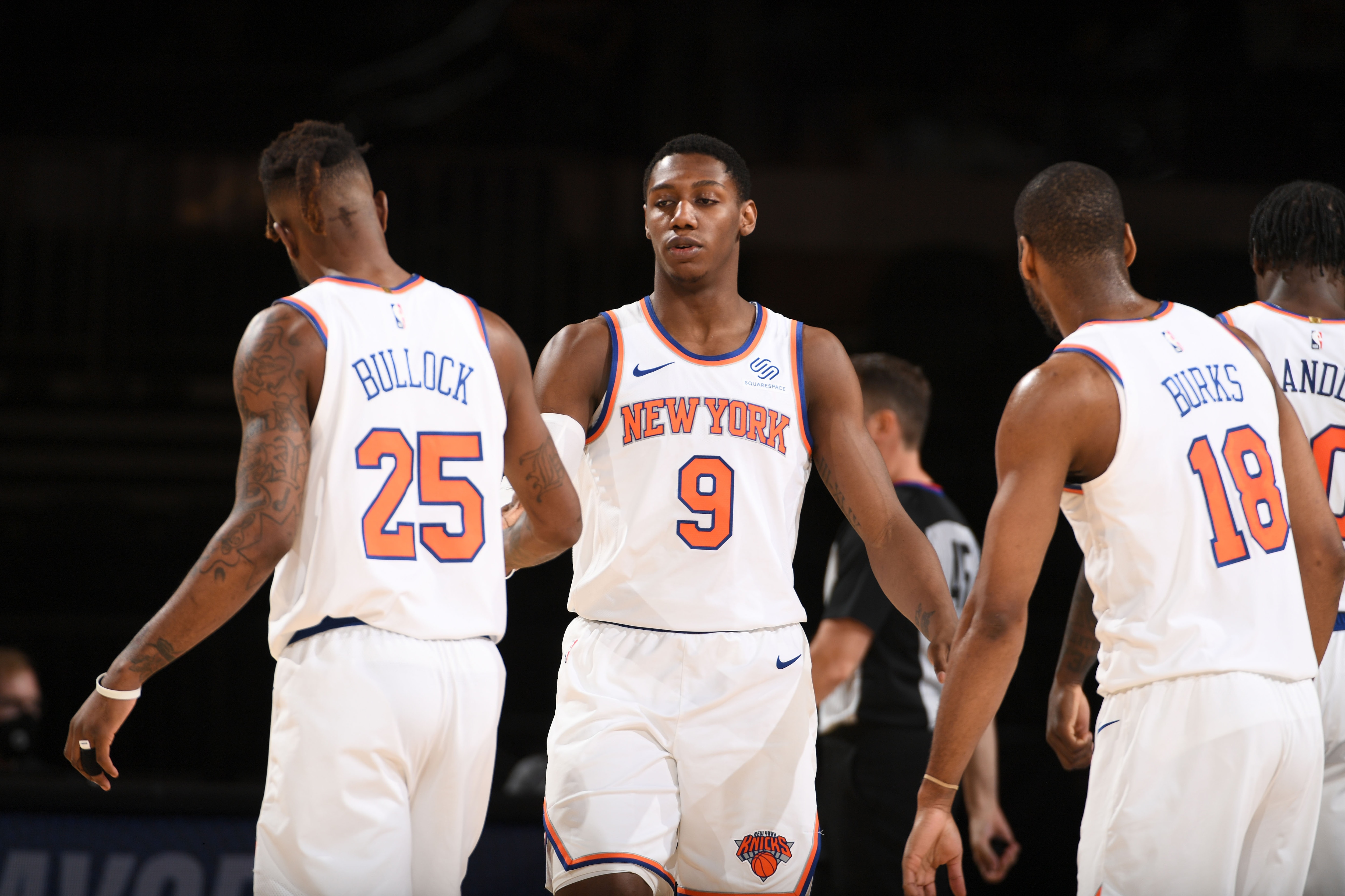 NEW YORK, NY - MAY 16: RJ Barrett #9 hi-fives Reggie Bullock #25 of the New York Knicks during the game against the Boston Celtics on May 16, 2021 at Madison Square Garden in New York City, New York.  NOTE TO USER: User expressly acknowledges and agrees that, by downloading and or using this photograph, User is consenting to the terms and conditions of the Getty Images License Agreement. Mandatory Copyright Notice: Copyright 2021 NBAE  (Photo by Garrett Ellwood/NBAE via Getty Images)