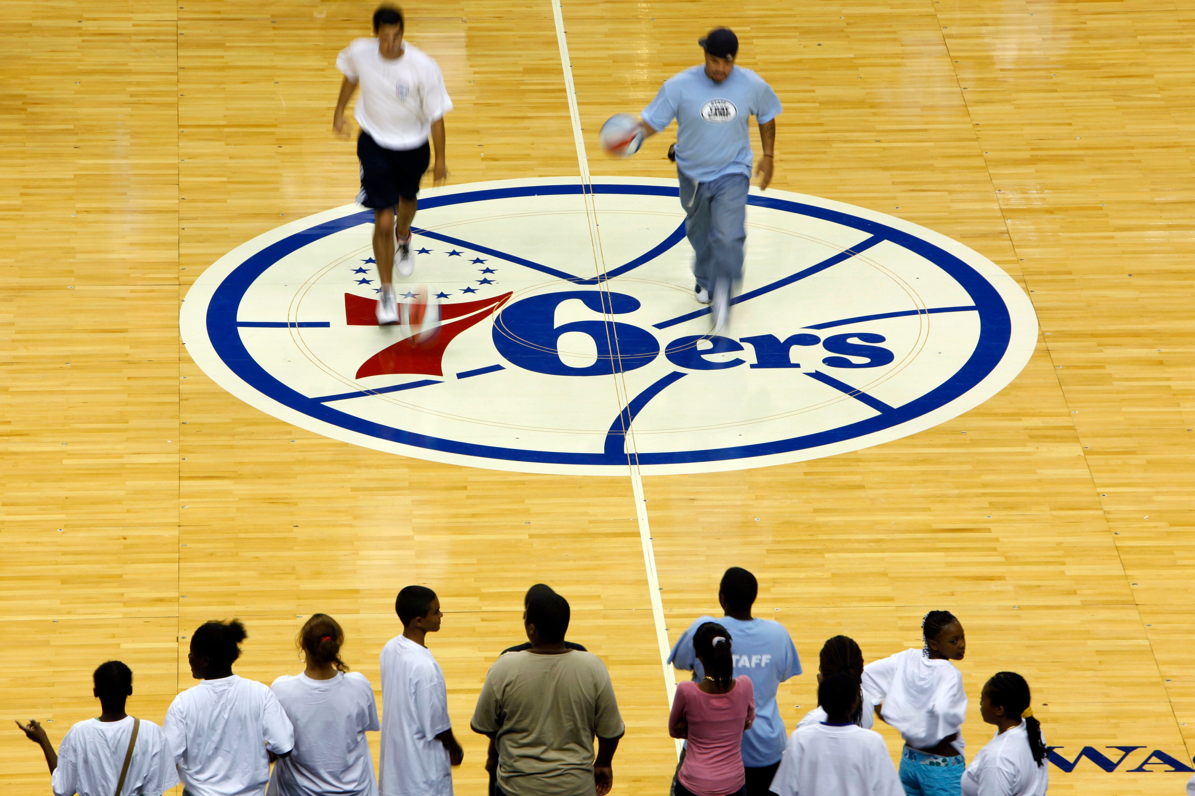 Dribbling exercises are demonstrate on the newly designed Philadelphia 76ers basketball court for the upcoming 2009-10 season, during the Summer Hoops Tour basketball clinic, in Philadelphia, Monday, Aug. 10, 2009.  The logo was last used in the 1996-97 season. (AP Photo/Matt Rourke)