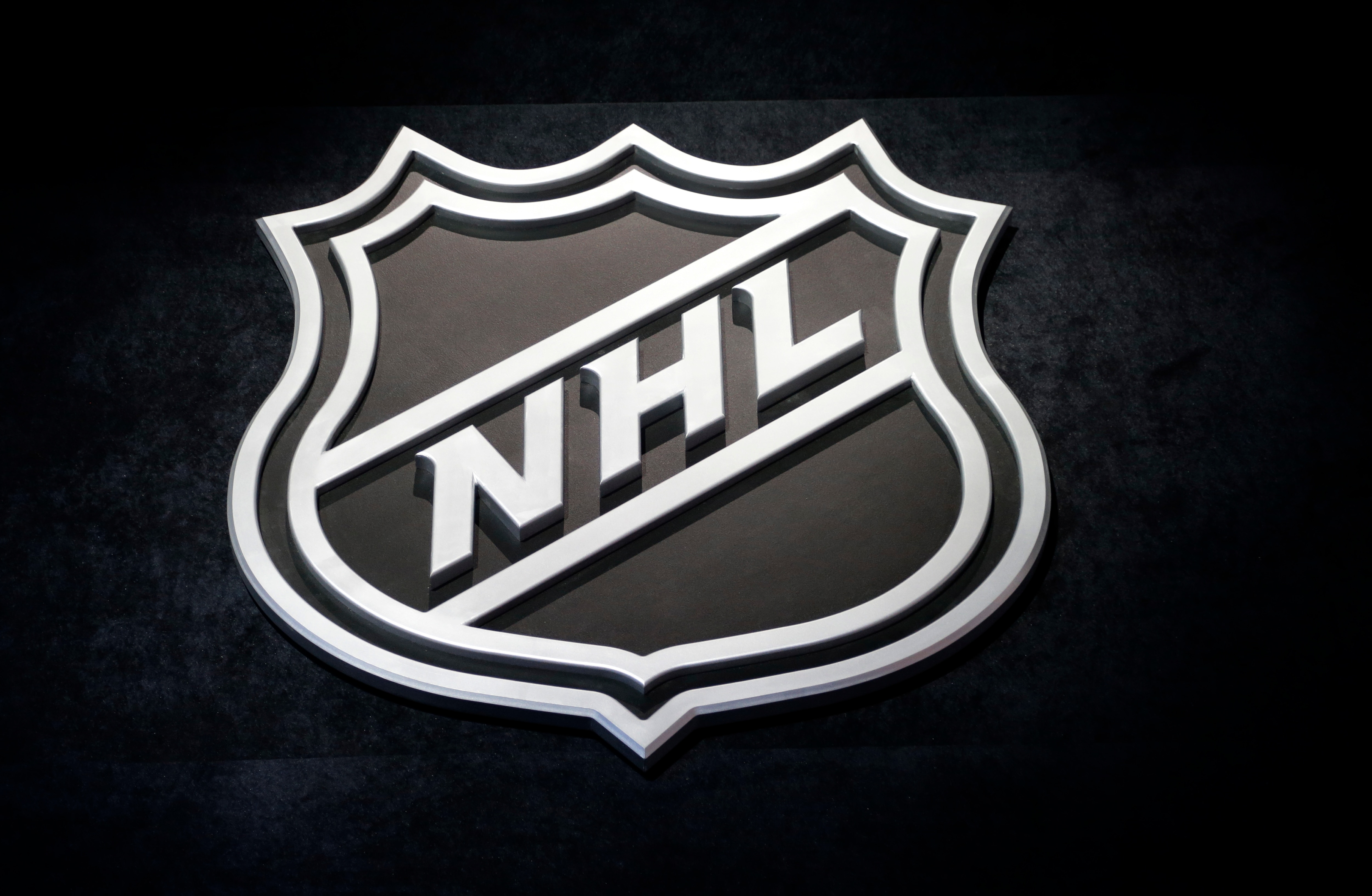 FILE - In this June 26, 2015, file photo, an NHL logo is shown before the start of the first round of the NHL hockey draft, in Sunrise, Fla. The NHL Free Agency period begins at noon Sunday, July 1, 2018. (AP Photo/Alan Diaz, File)