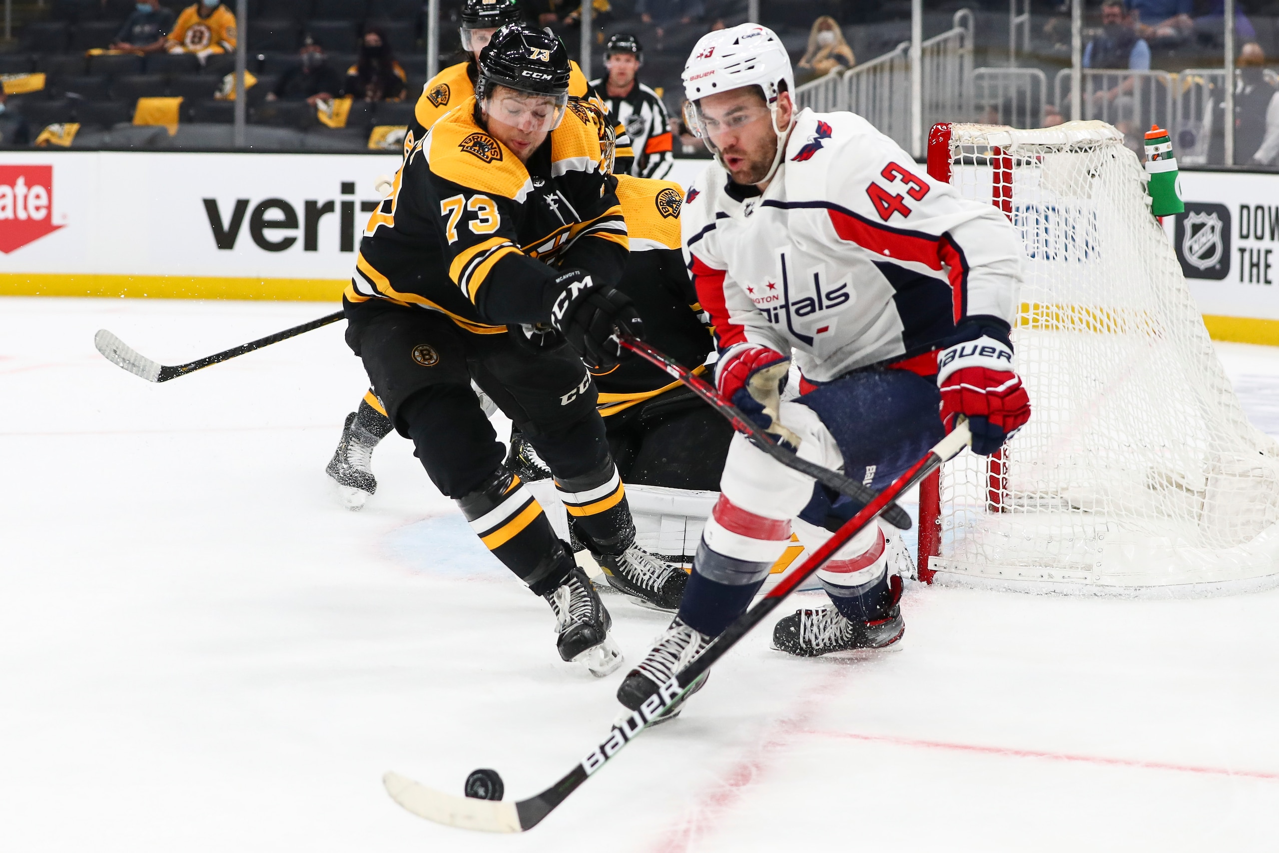 BOSTON, MA - MAY 19:  Tom Wilson #43 of the Washington Capitals fights for the puck with Charlie McAvoy #73 of the Boston Bruins in Game Three of the First Round of the 2021 Stanley Cup Playoffs at TD Garden on May 19, 2021 in Boston, Massachusetts. (Photo by Adam Glanzman/Getty Images)