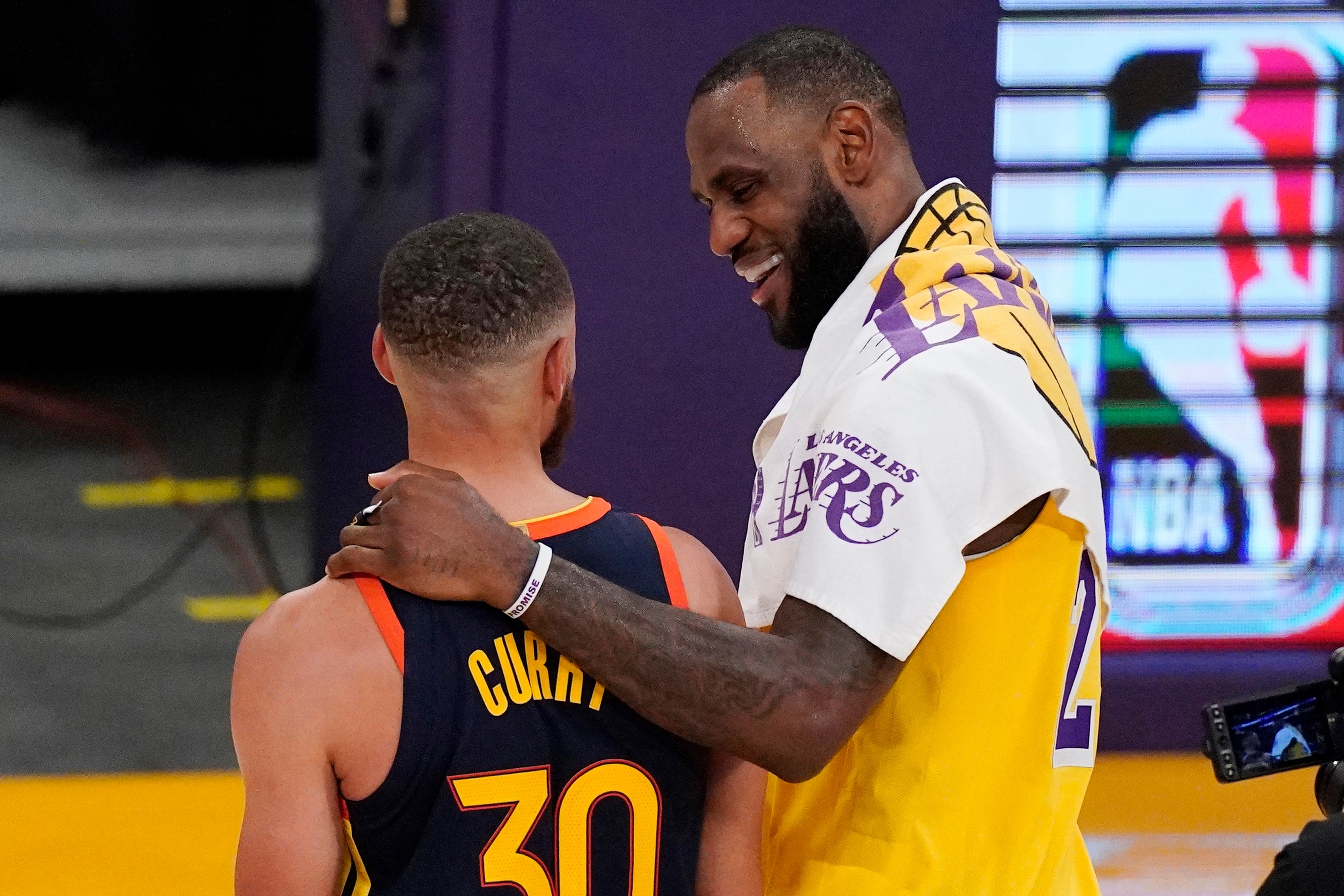 Los Angeles Lakers forward LeBron James, right, greets Golden State Warriors guard Stephen Curry after the Lakers defeated the Golden State Warriors 103-100 in an NBA basketball Western Conference Play-In game Wednesday, May 19, 2021, in Los Angeles. (AP Photo/Mark J. Terrill)