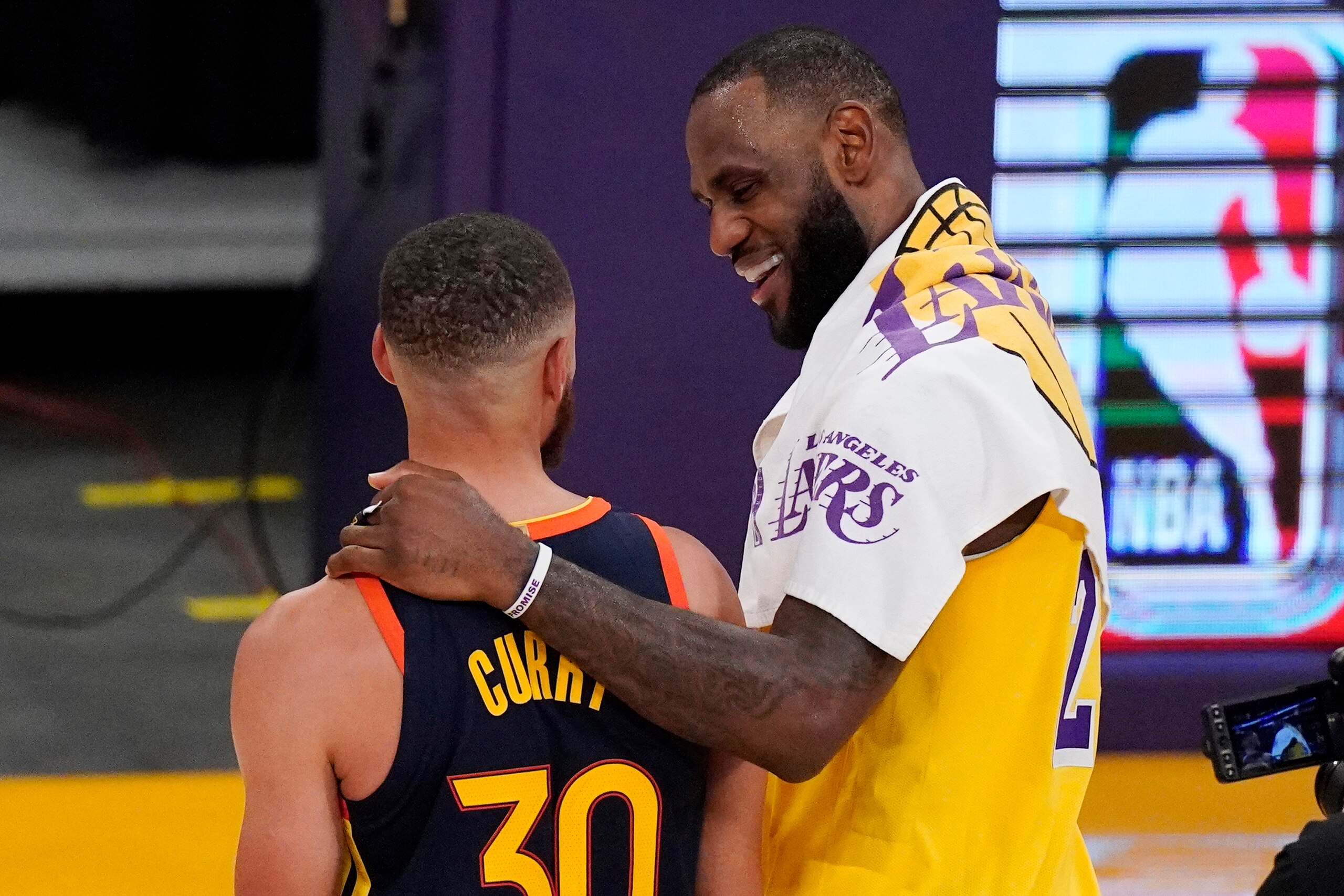Los Angeles Lakers forward LeBron James, right, greets Golden State Warriors guard Stephen Curry after the Lakers defeated the Golden State Warriors 103-100 in an NBA basketball Western Conference Play-In game Wednesday, May 19, 2021, in Los Angeles. (AP Photo/Mark J. Terrill)