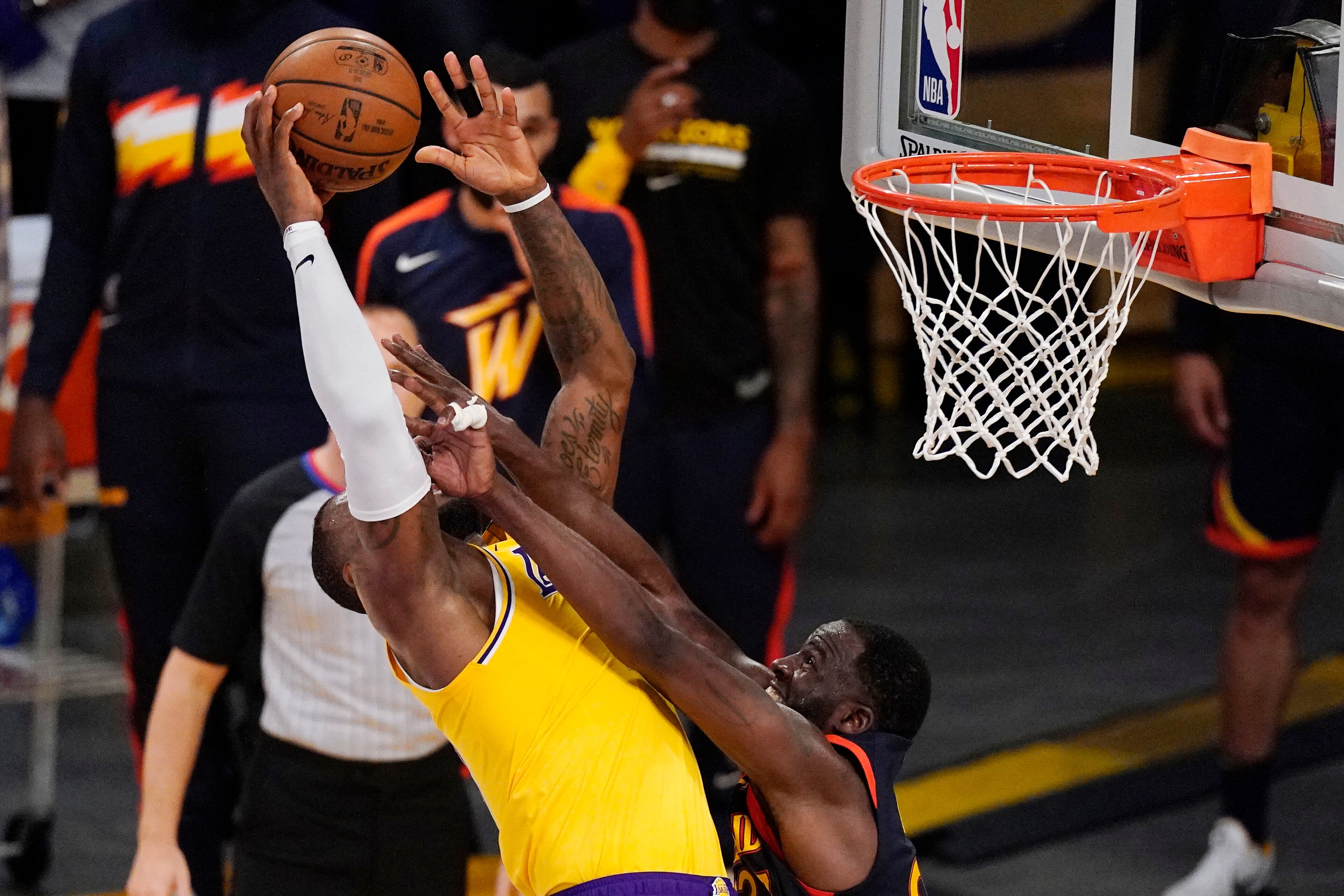 Los Angeles Lakers forward LeBron James, left, is fouled while shooting by Golden State Warriors forward Draymond Green during the second half of an NBA basketball Western Conference Play-In game Wednesday, May 19, 2021, in Los Angeles. (AP Photo/Mark J. Terrill)