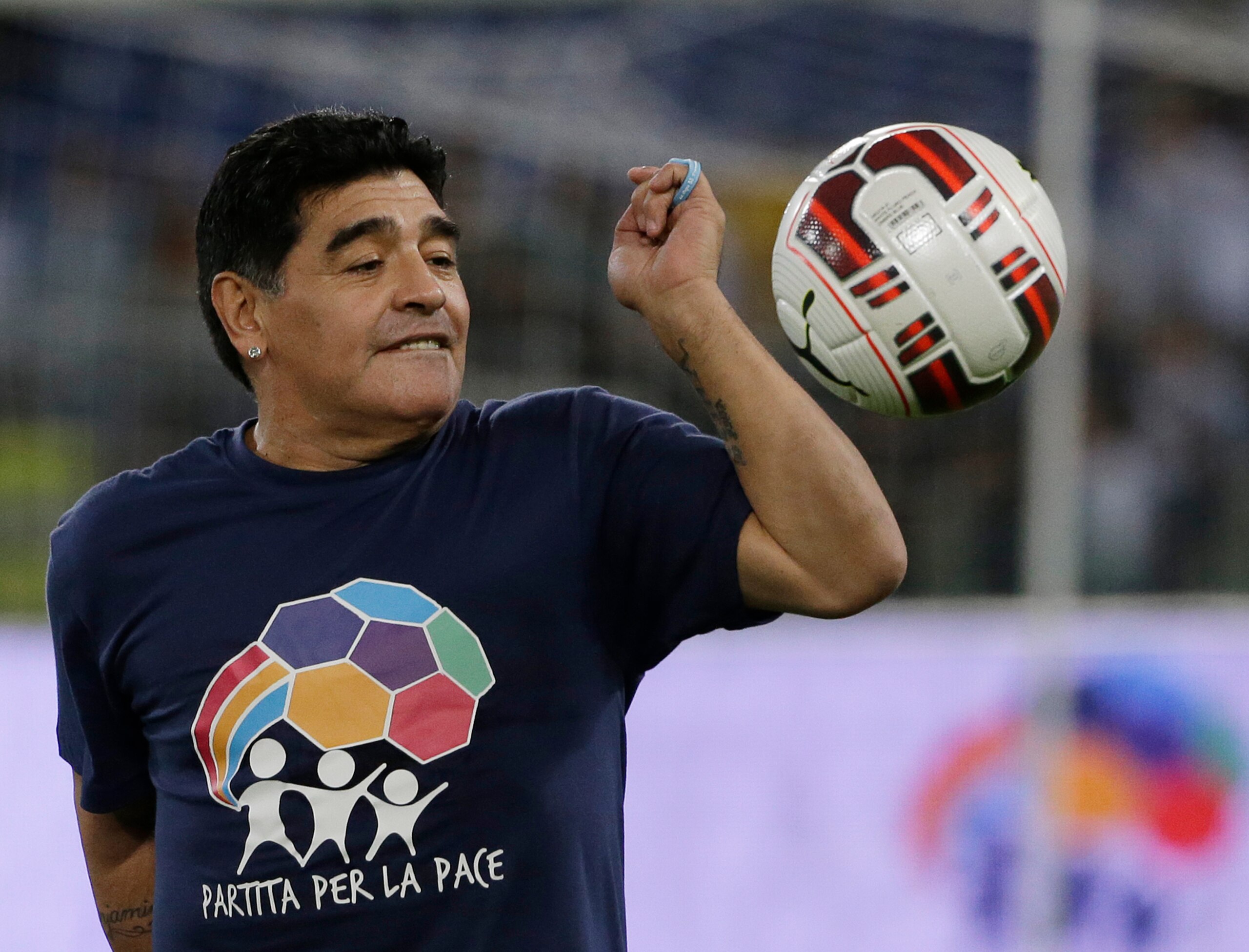 FILE - In this Monday, Sept. 1, 2014 file photo, Argentine soccer legend Diego Armando Maradona watches the ball as he warms up prior to the start of an inter-religious match for peace, supported by Pope Francis to promote the dialogue and peace among different religions, at Rome's Olympic Stadium. Diego Maradona has died. The Argentine soccer great was among the best players ever and who led his country to the 1986 World Cup title before later struggling with cocaine use and obesity. He was 60. (AP Photo/Gregorio Borgia, File)