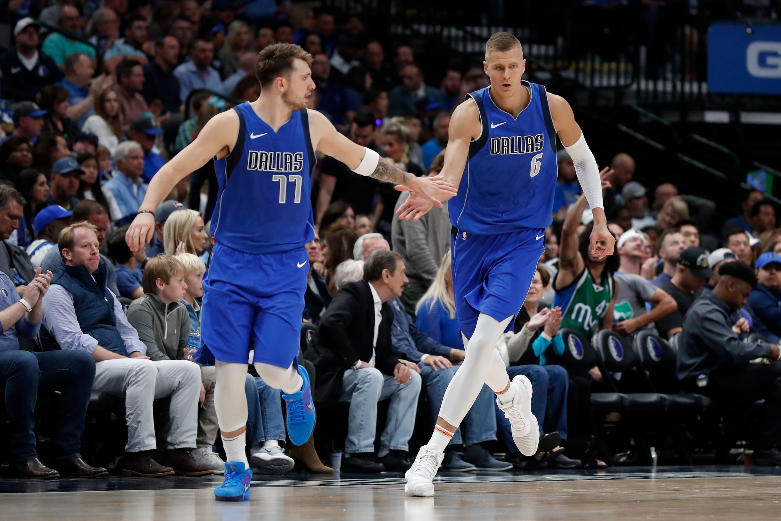 Dallas Mavericks' Luka Doncic (77) and Kristaps Porzingis (6) celebrate a basket by Porzingis in the second half of an NBA basketball game against the Portland Trail Blazers in Dallas, Sunday, Oct. 27, 2019. (AP Photo/Tony Gutierrez) Dallas Mavericks' Luka Doncic (77) and Kristaps Porzingis (6) celebrate a basket by Porzingis in the second half of an NBA basketball game against the Portland Trail Blazers in Dallas, Sunday, Oct. 27, 2019. (AP Photo/Tony Gutierrez)