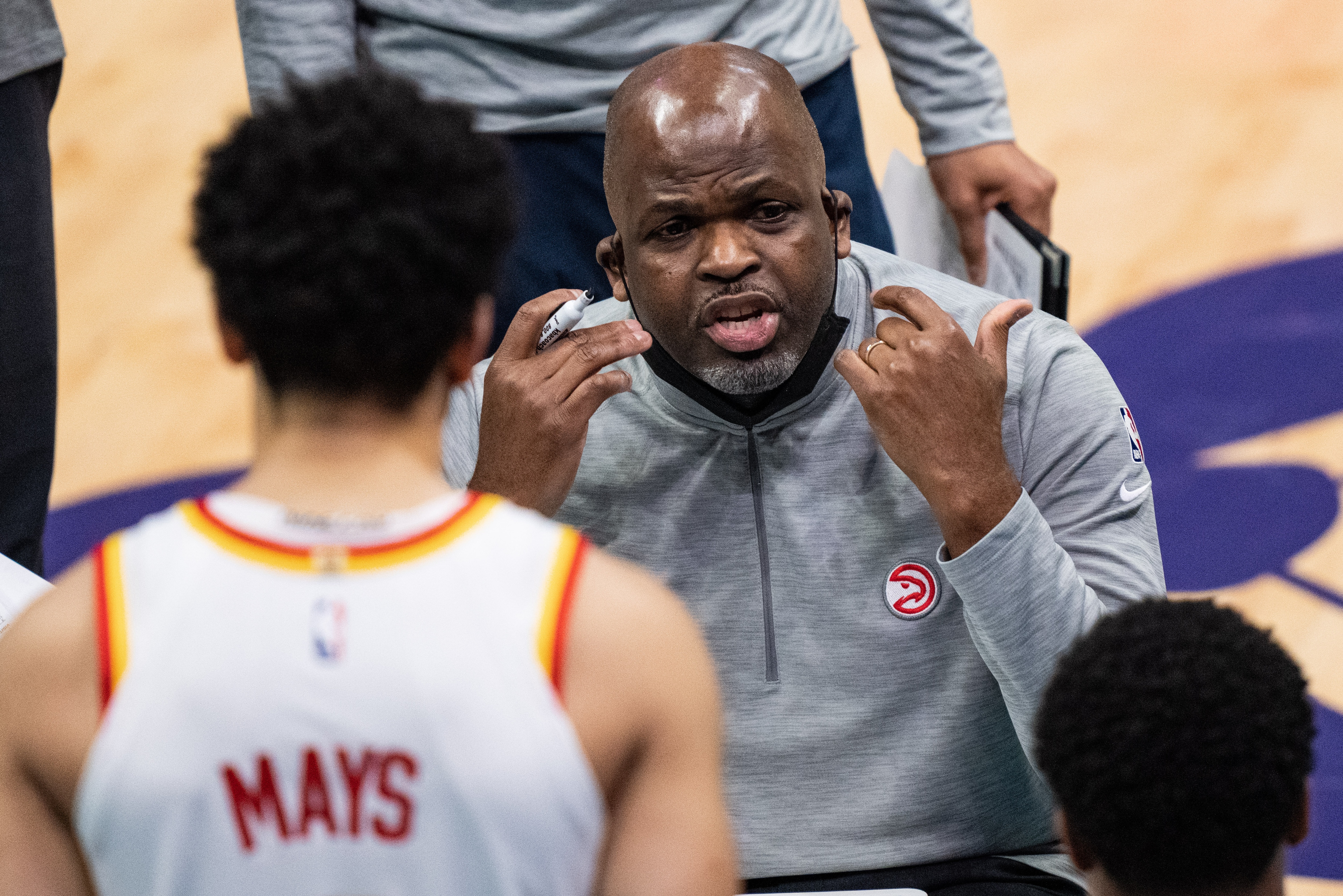 CHARLOTTE, NORTH CAROLINA - APRIL 11: Atlanta Hawks Head Coach Nate McMillan talks to his players during a time out during their game against the Charlotte Hornets at Spectrum Center on April 11, 2021 in Charlotte, North Carolina. NOTE TO USER: User expressly acknowledges and agrees that, by downloading and or using this photograph, User is consenting to the terms and conditions of the Getty Images License Agreement. (Photo by Jacob Kupferman/Getty Images)