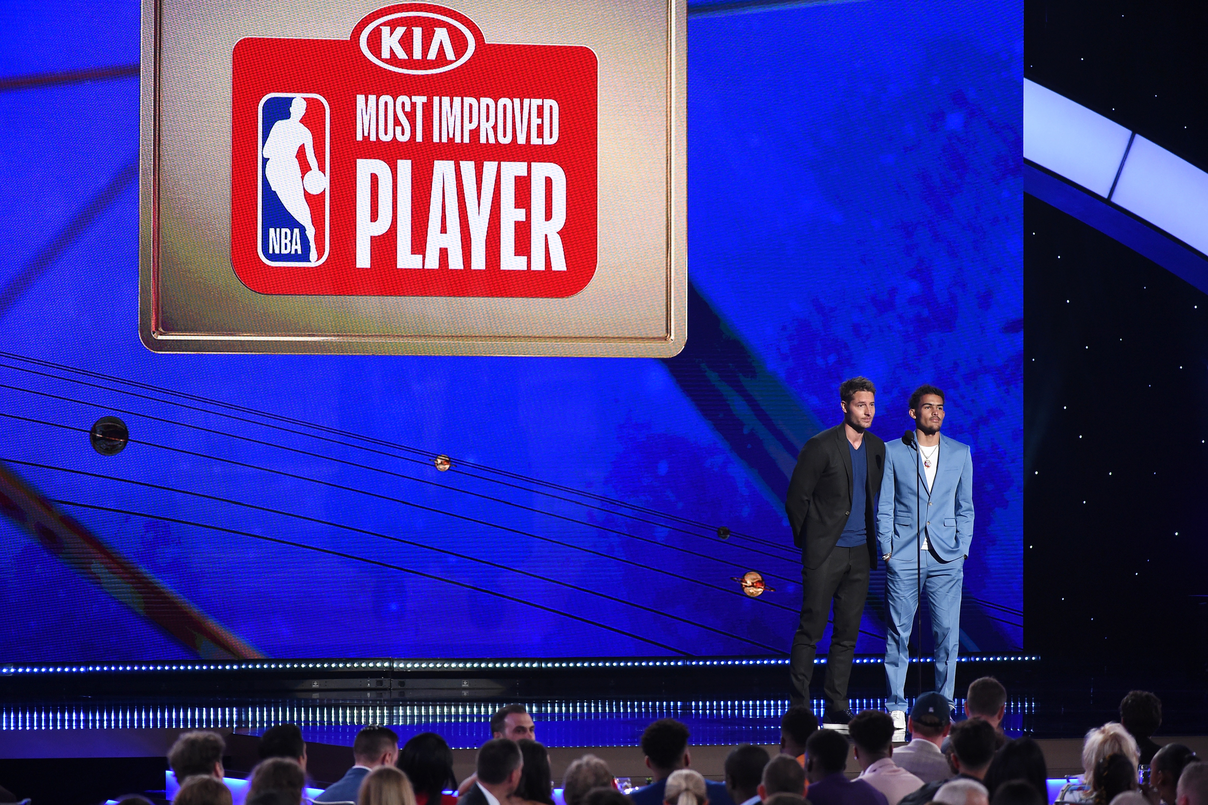 SANTA MONICA, CA - JUNE 24:  Actor Justin Hartley and Trae Young #11 of the Atlanta Hawks present the KIA Most Improved Player Award during the 2019 NBA Awards Show on June 24, 2019 at Barker Hangar in Santa Monica, California. NOTE TO USER: User expressly acknowledges and agrees that, by downloading and/or using this photograph, user is consenting to the terms and conditions of the Getty Images License Agreement. Mandatory Copyright Notice: Copyright 2019 NBAE  (Photo by Adam Pantozzi/NBAE via Getty Images)
